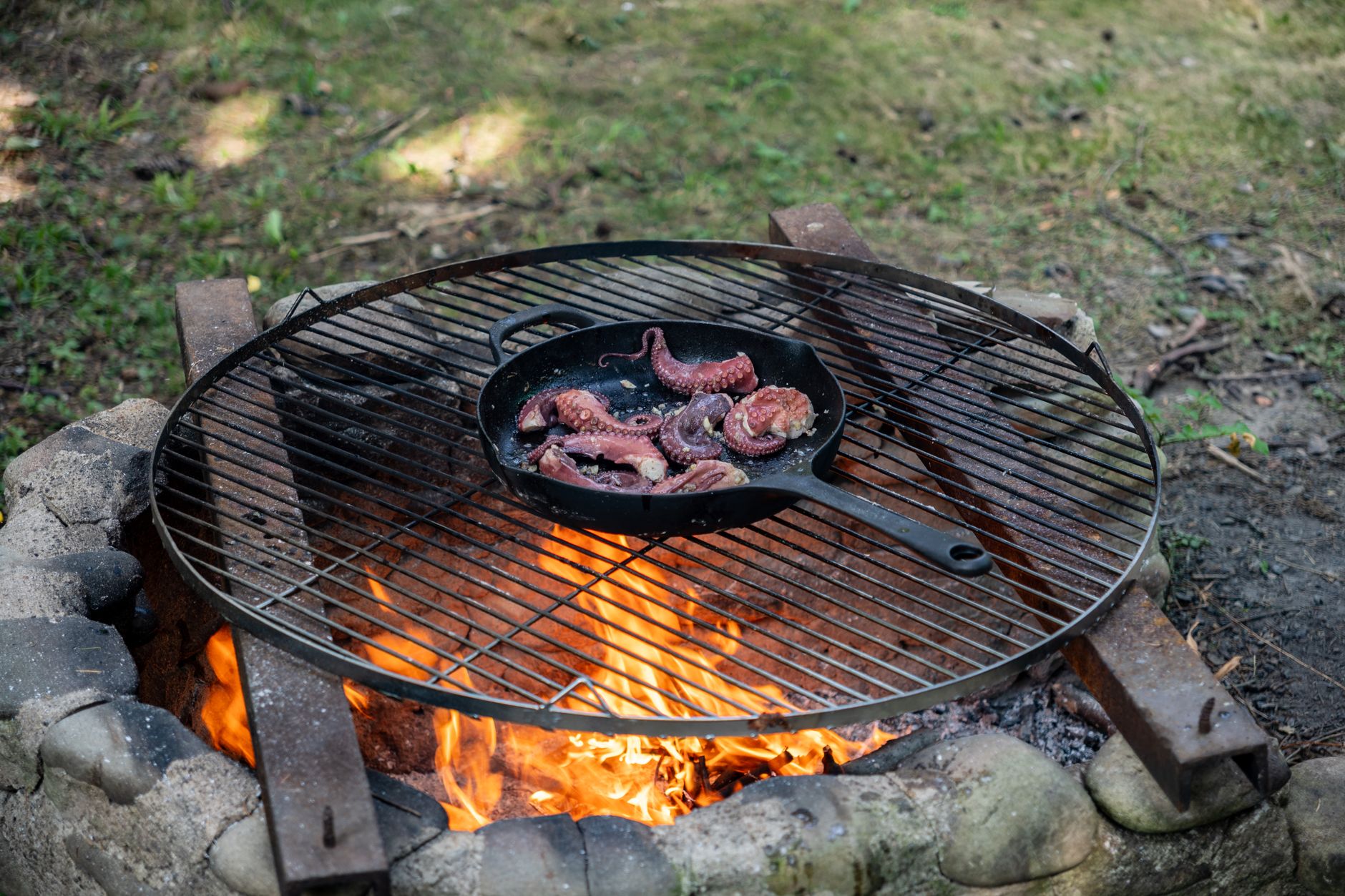 A skillet over an outdoor fire pit