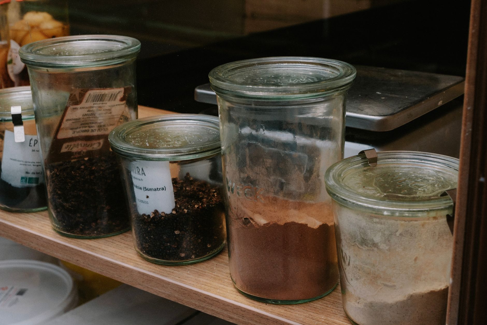 Jars of spices on a kitchen shelf