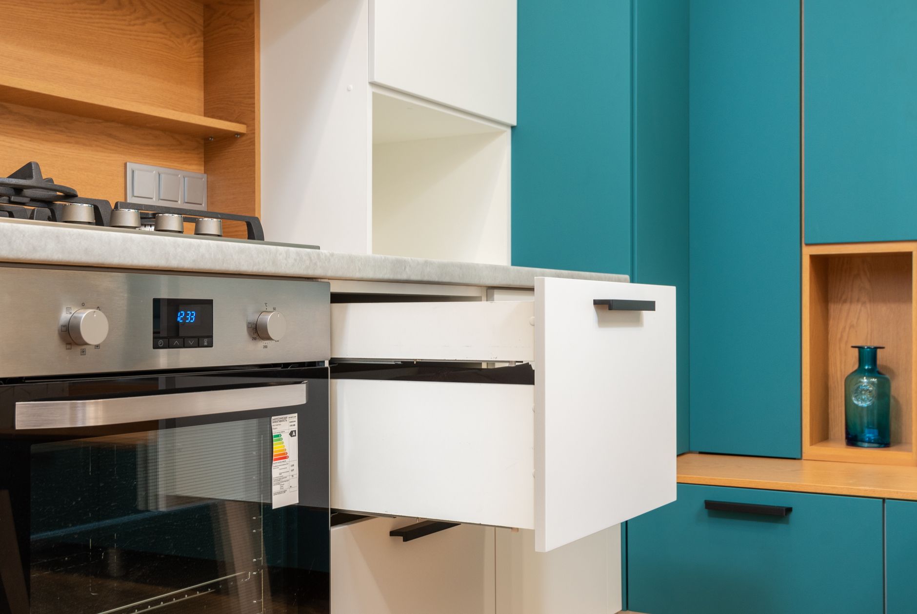 Kitchen drawers beside a built-in oven