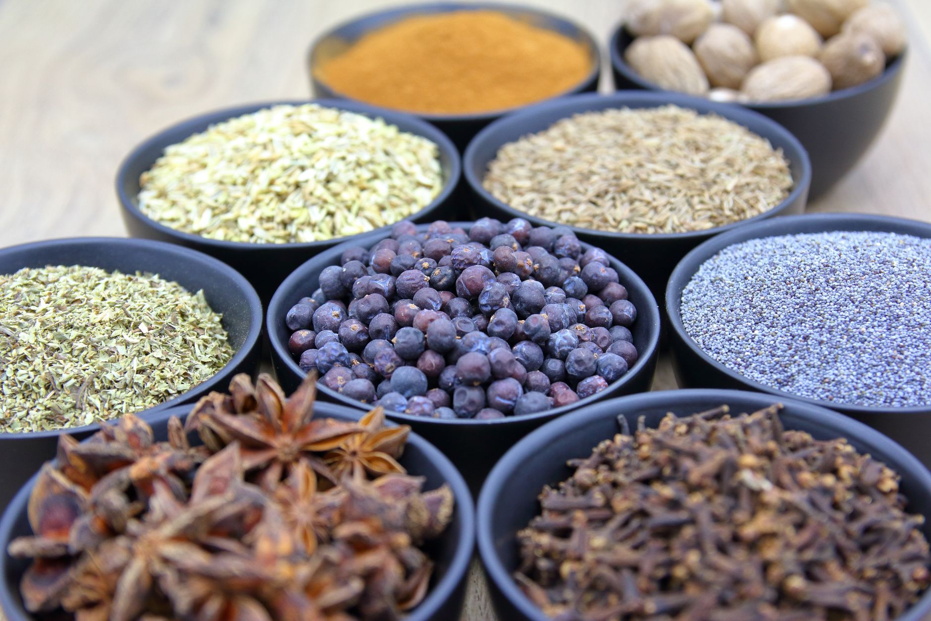 Small bowls of colorful ground spices and dried herbs