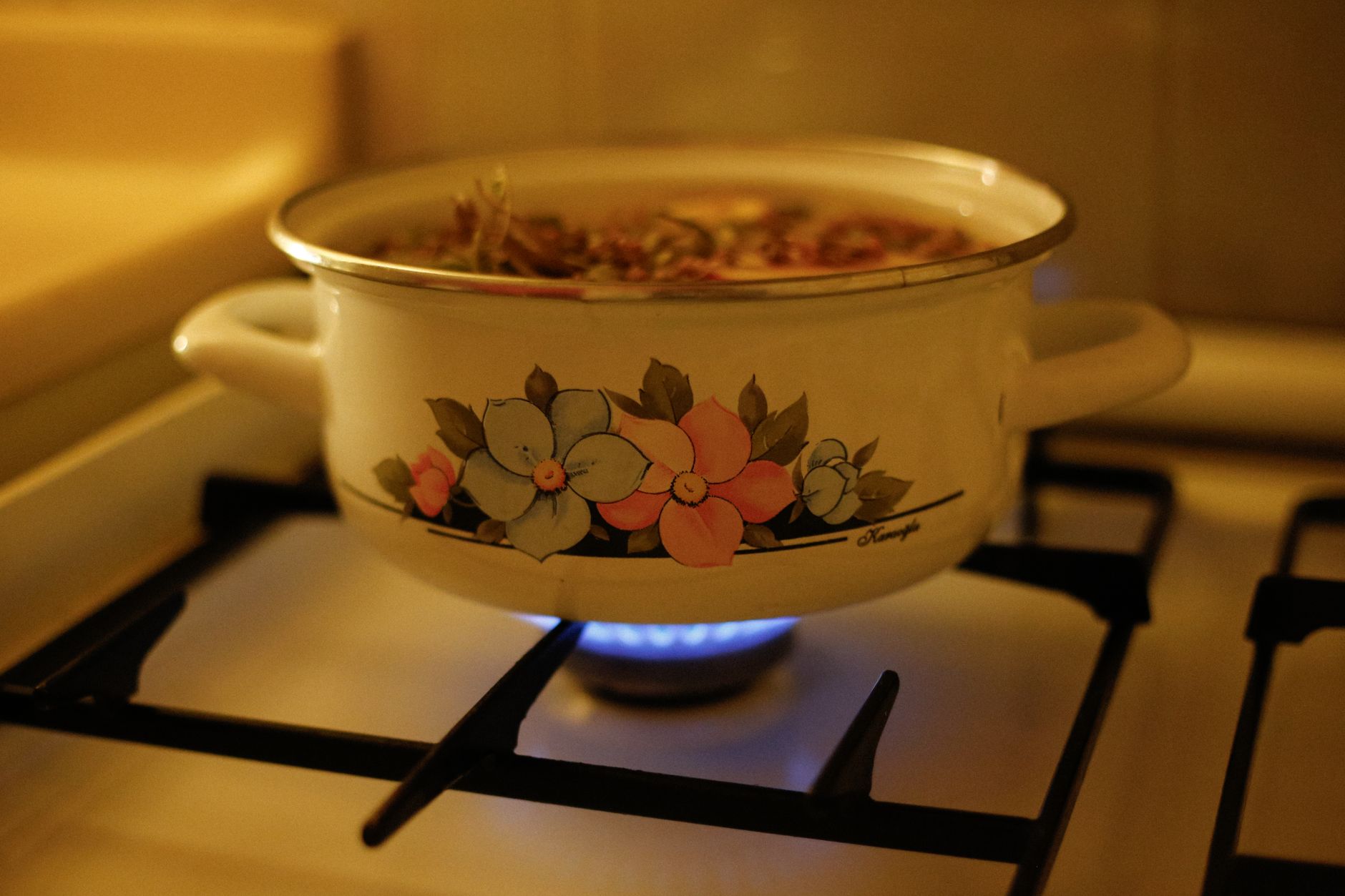 A pot cooking on a gas burner