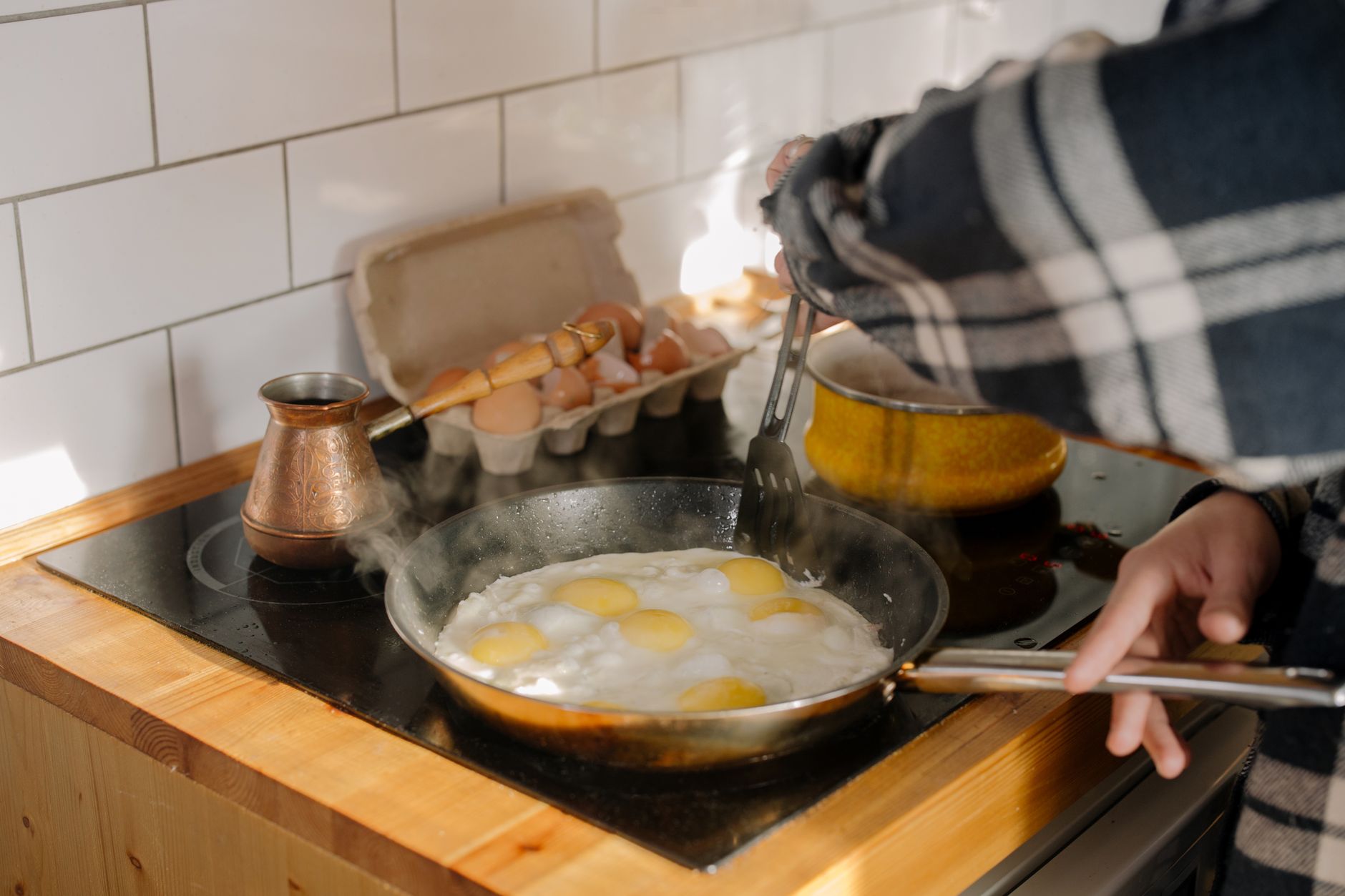 Eggs frying in a pan on a cooktop