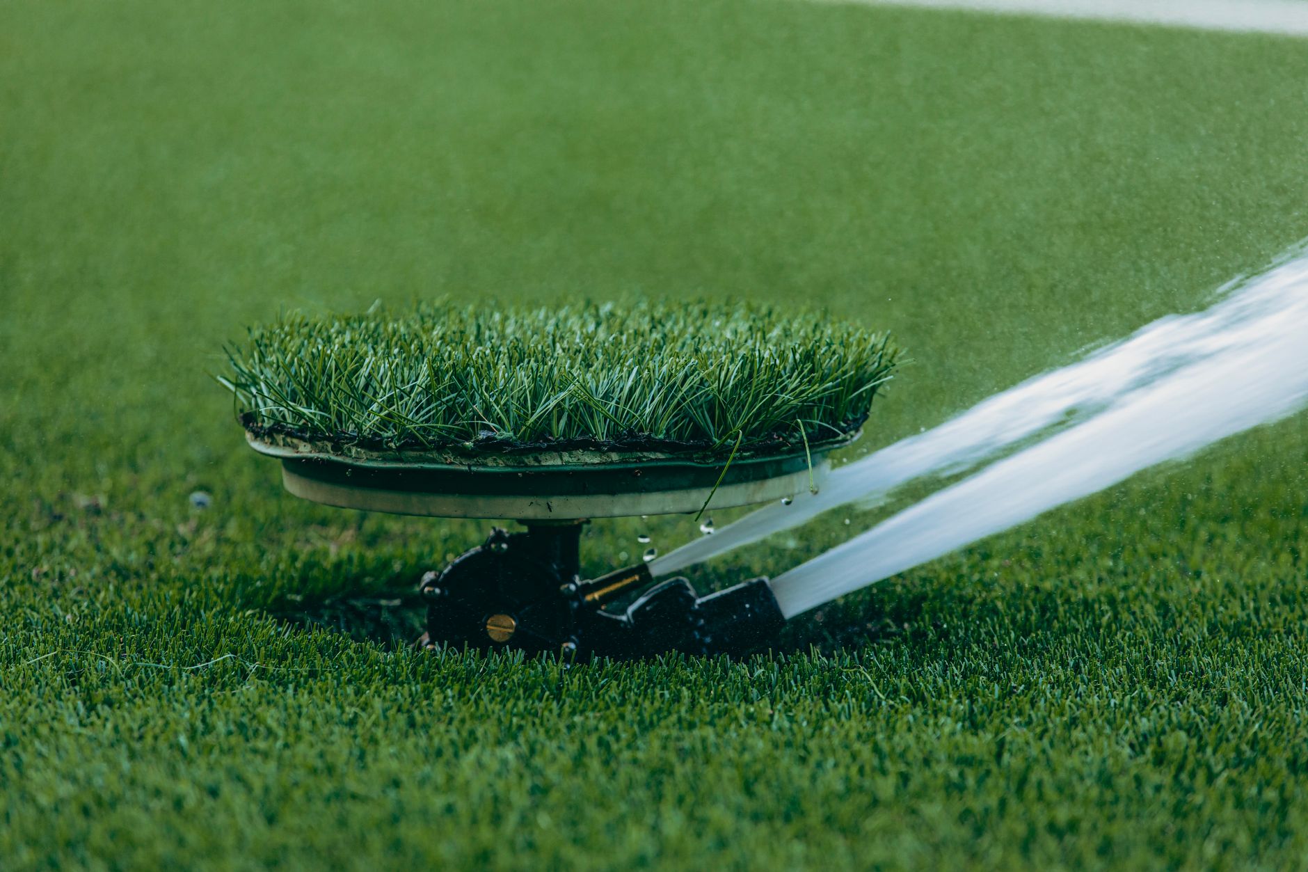 Best sprinkler: a sprinkler spraying water across a lawn