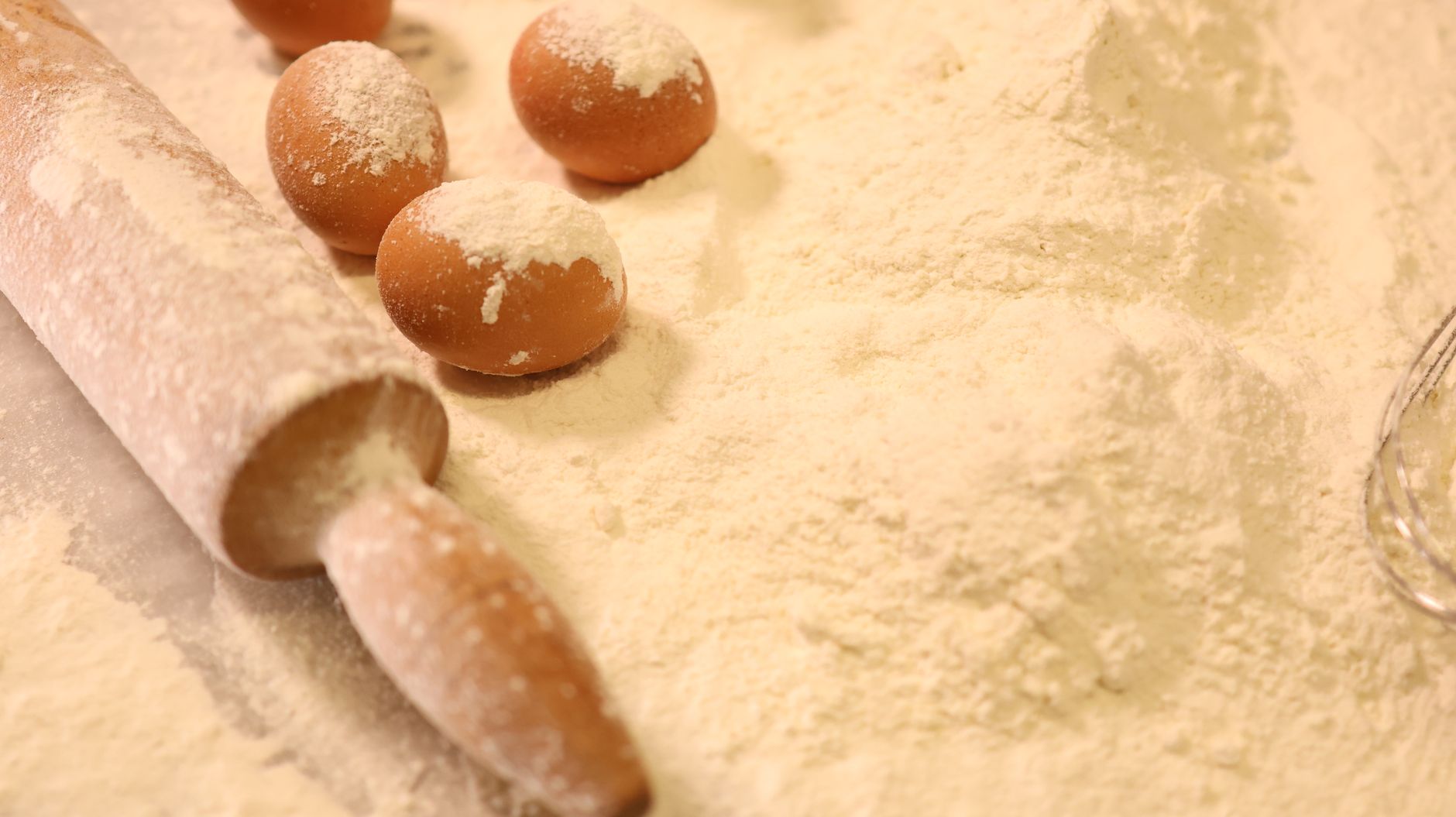 Eggs and a rolling pin in flour