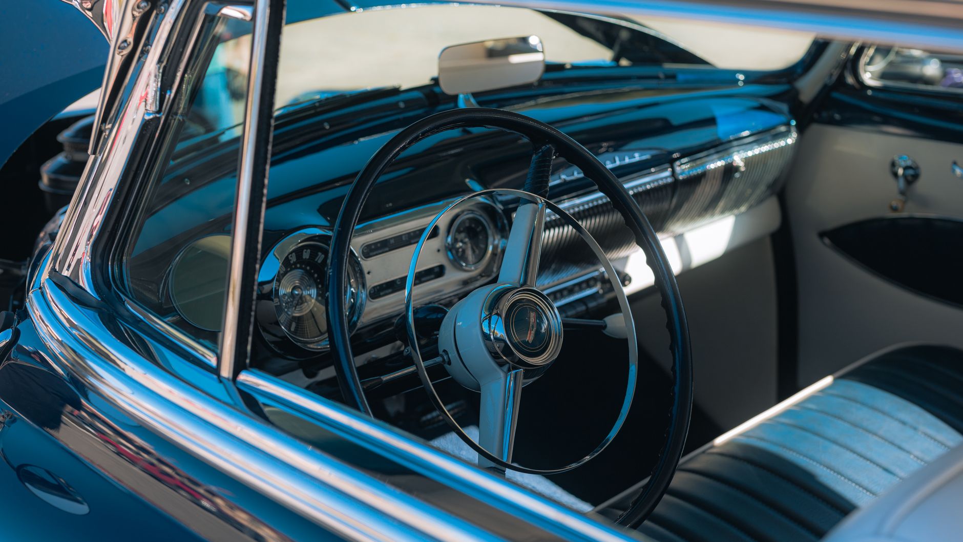 The steering wheel and dashboard of a classic car