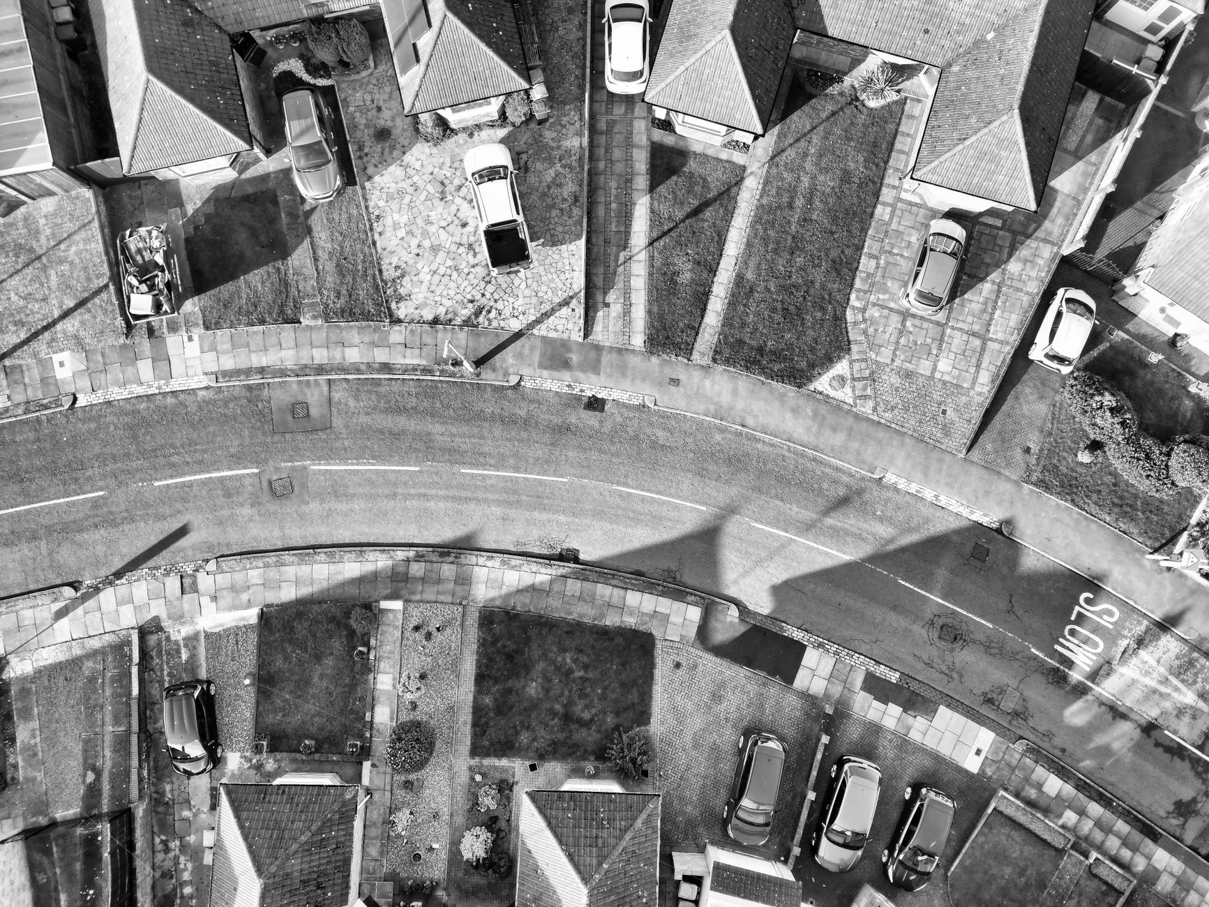 Aerial view of houses and driveways along a street