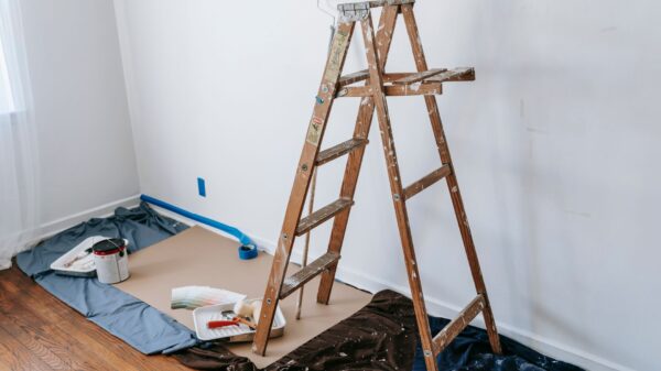 A wooden step ladder in a room being painted