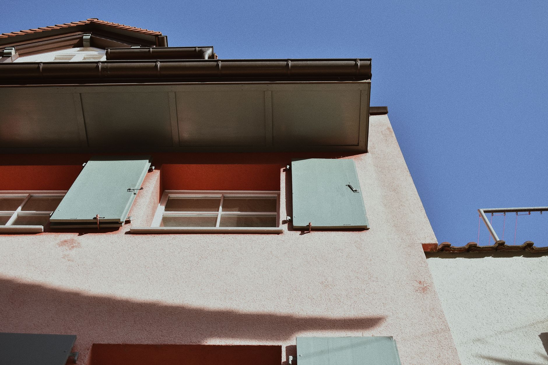 The eaves of a house against blue sky