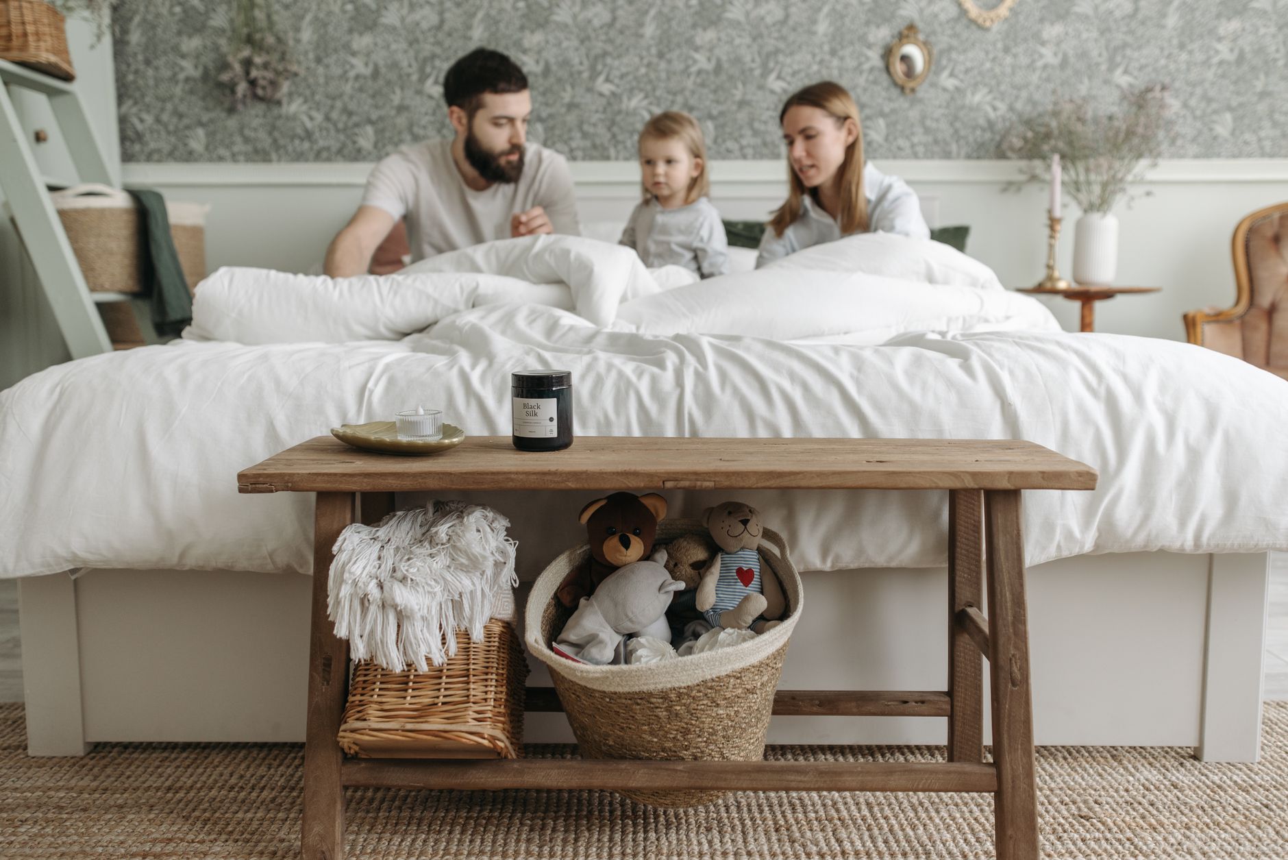 A bench at the foot of a made bed