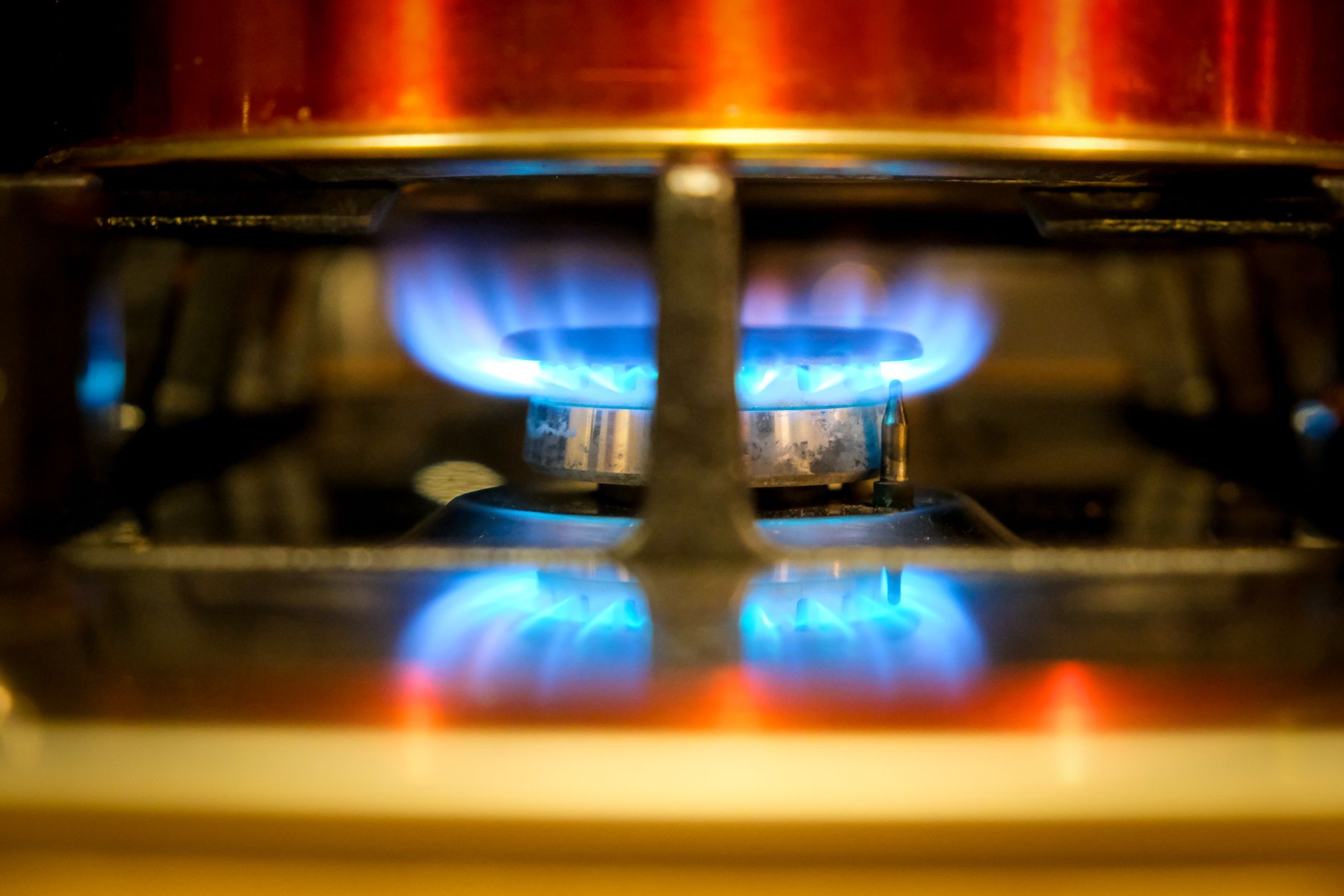 A blue flame on a gas stove burner