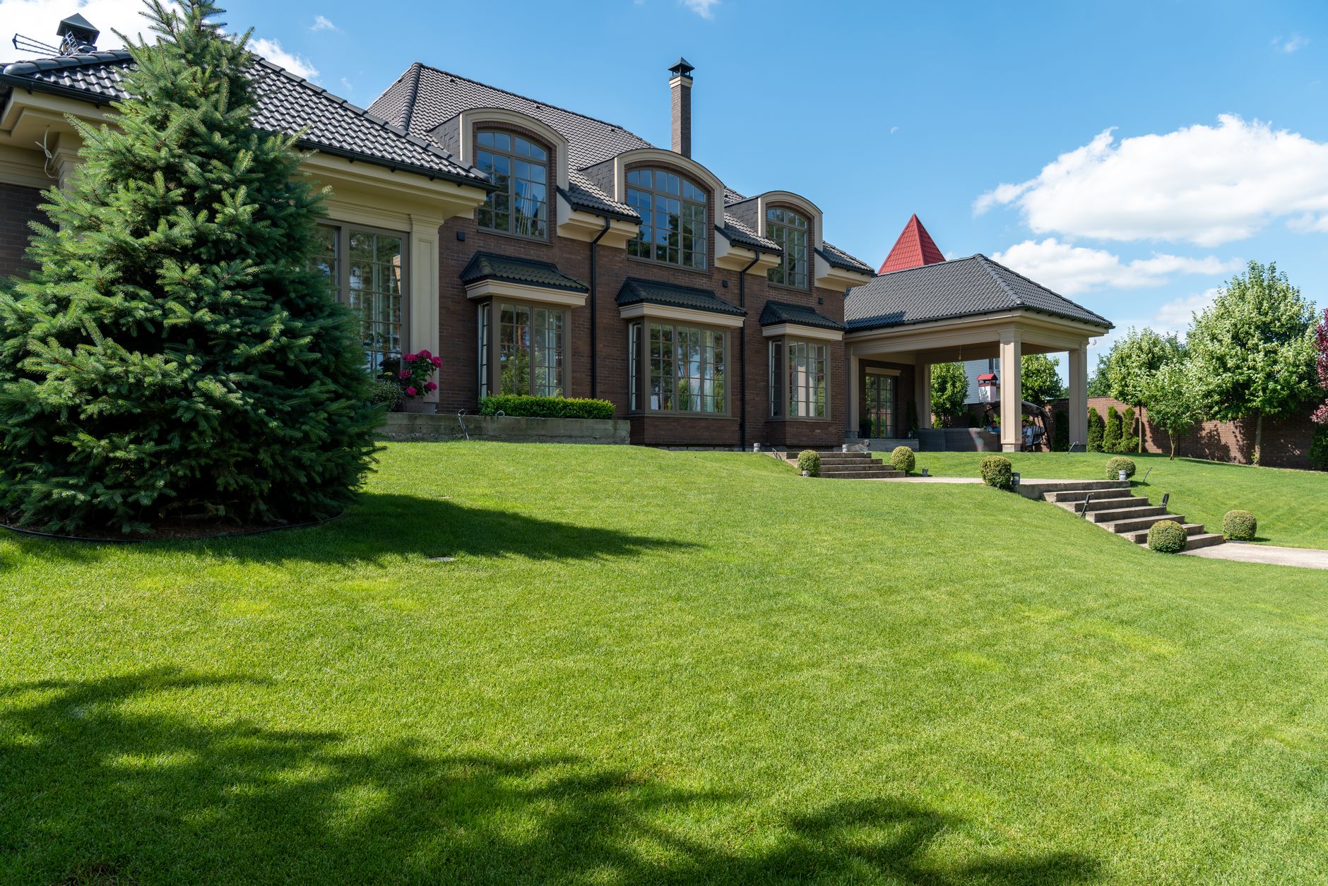 A large house with a trimmed lawn