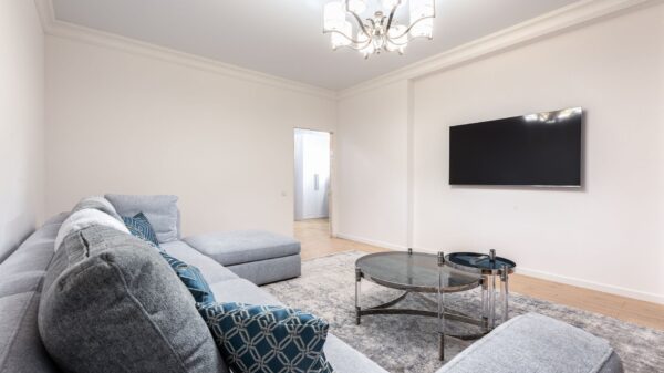 A living room with a wall-mounted TV
