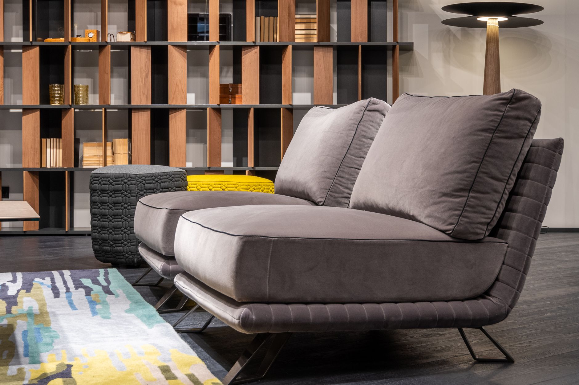 A sofa in front of a wall of shelves