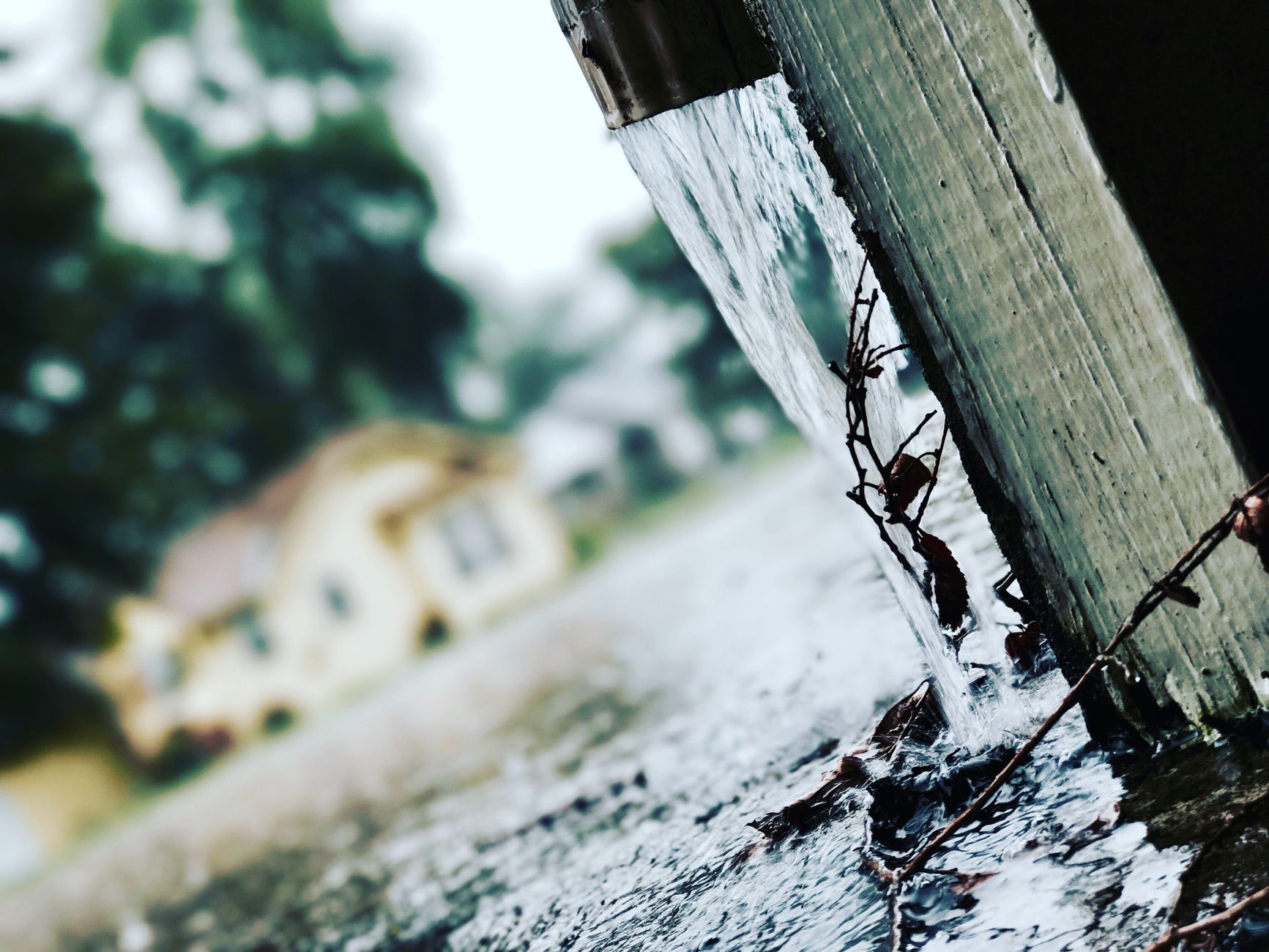 Rain pouring from a gutter
