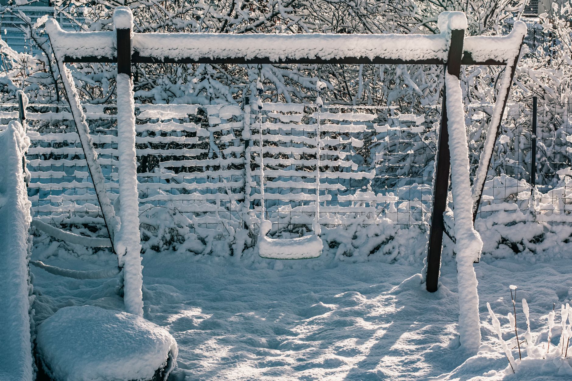 A snow-covered swing set