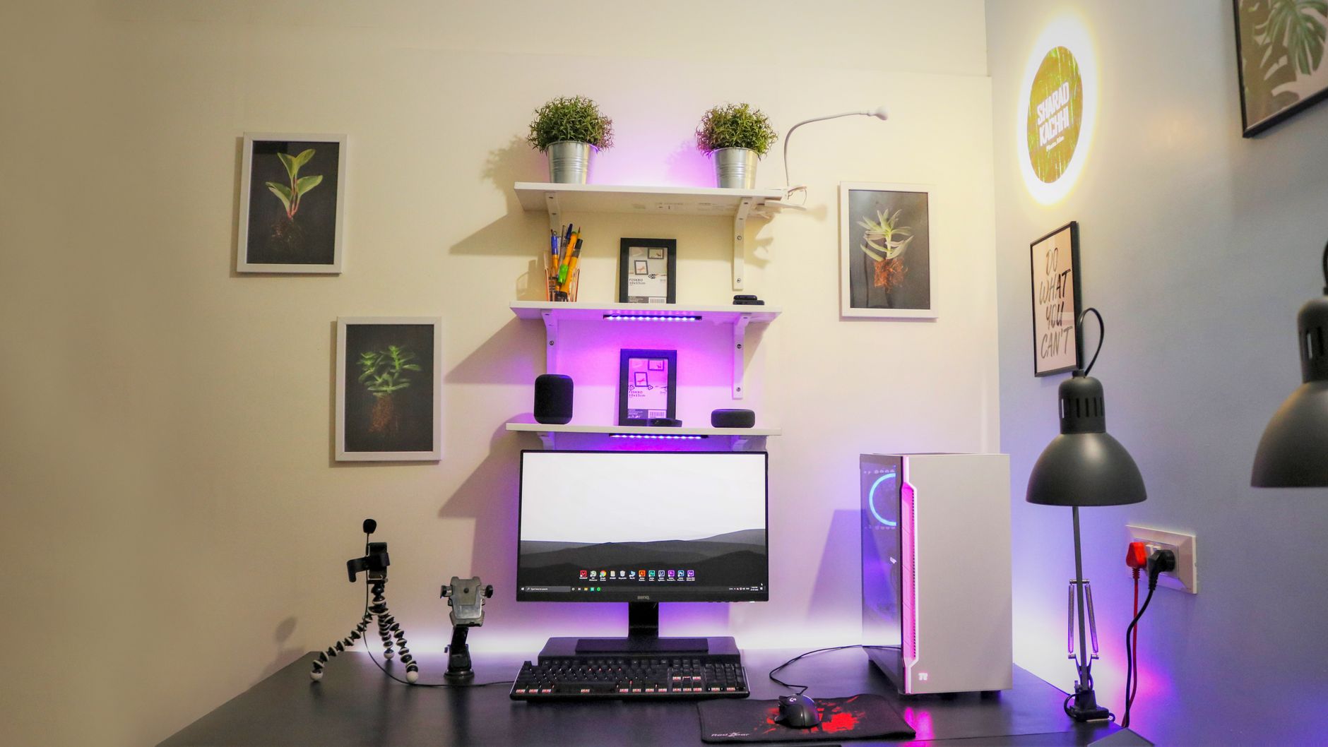 A home office desk with a computer and shelves