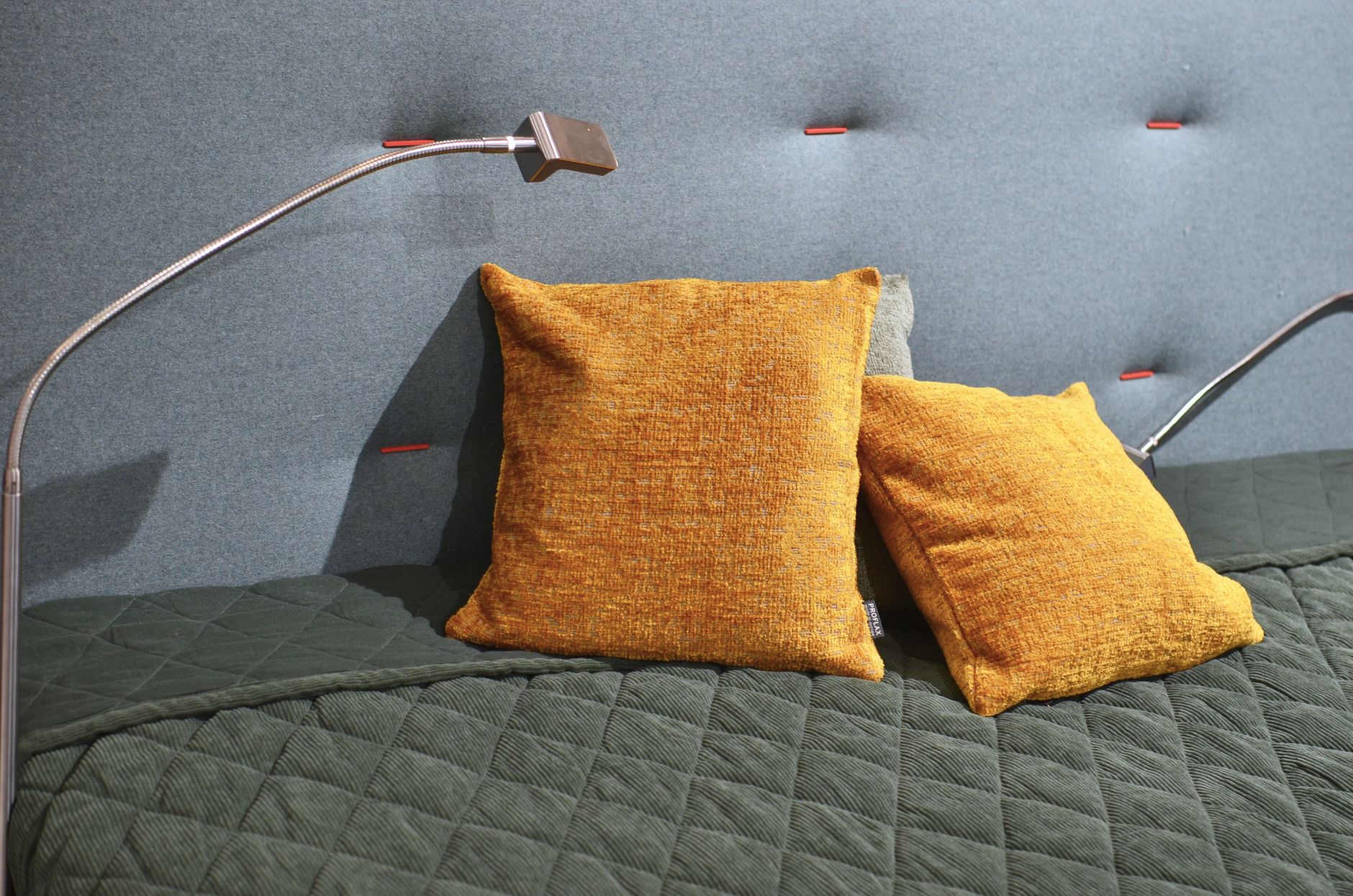 A bedside lamp lighting a reading spot in a bedroom