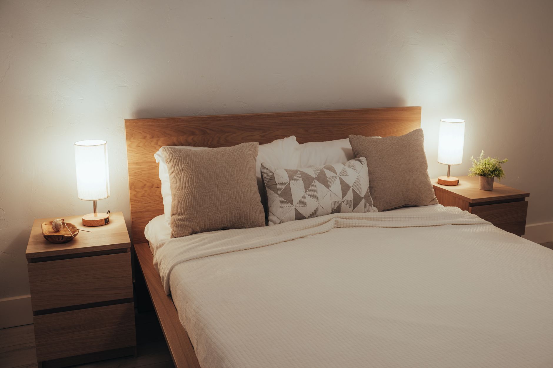 A warm lamp glow in a cozy bedroom