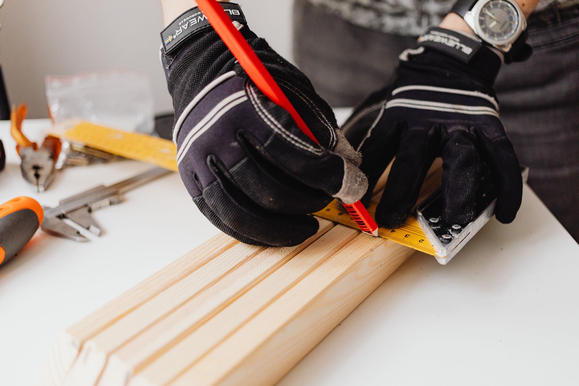 Marking a measurement on wood before cutting