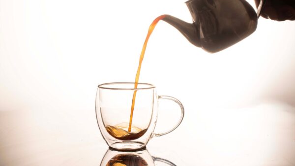 Best tea maker: tea poured from a teapot into a glass cup