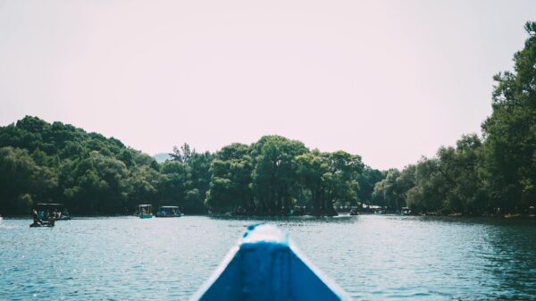 The bow of a small boat on a calm lake