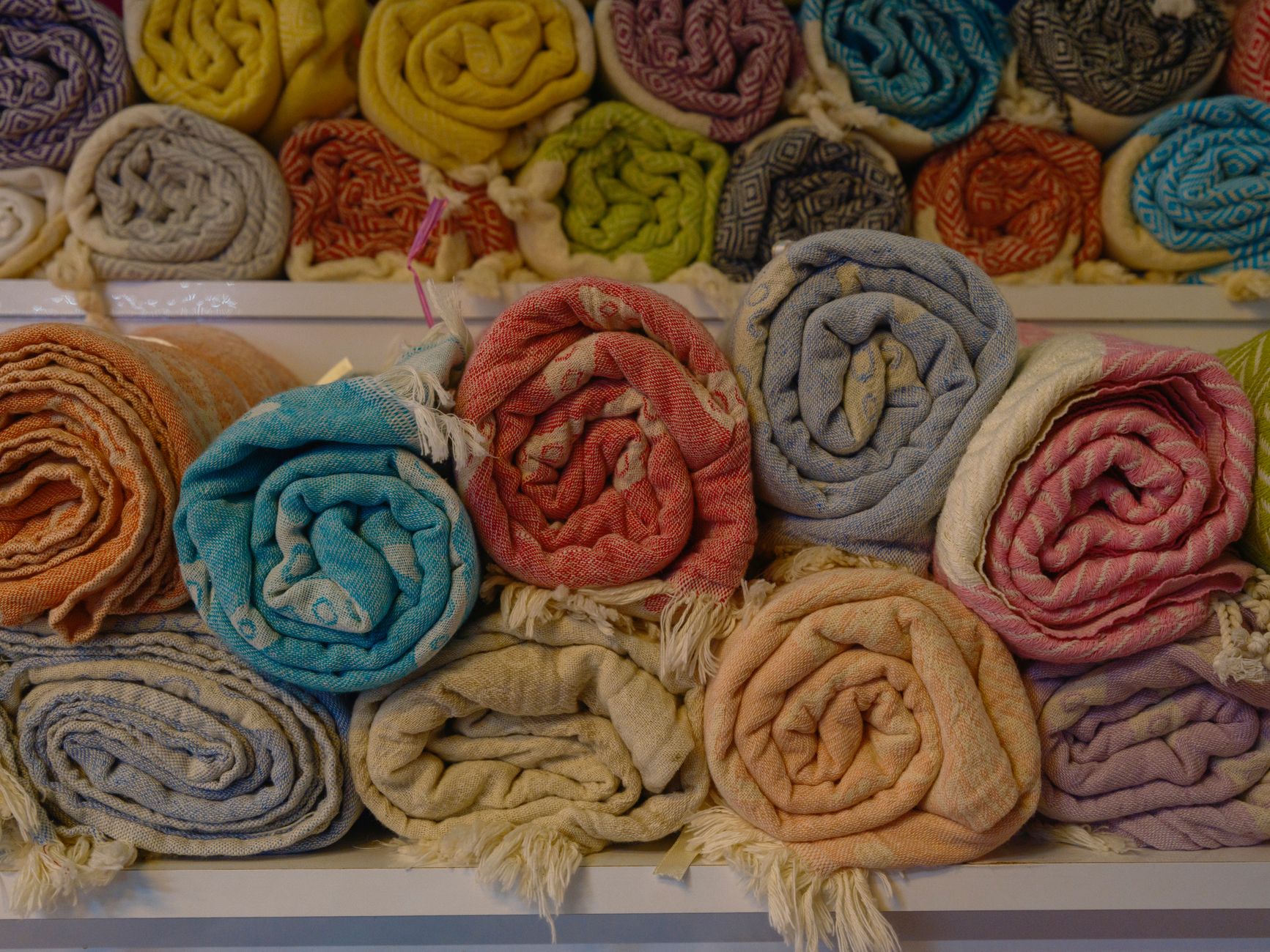 Folded blankets stacked on a shelf