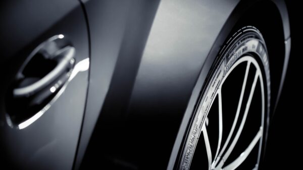 A close view of a car tire and wheel