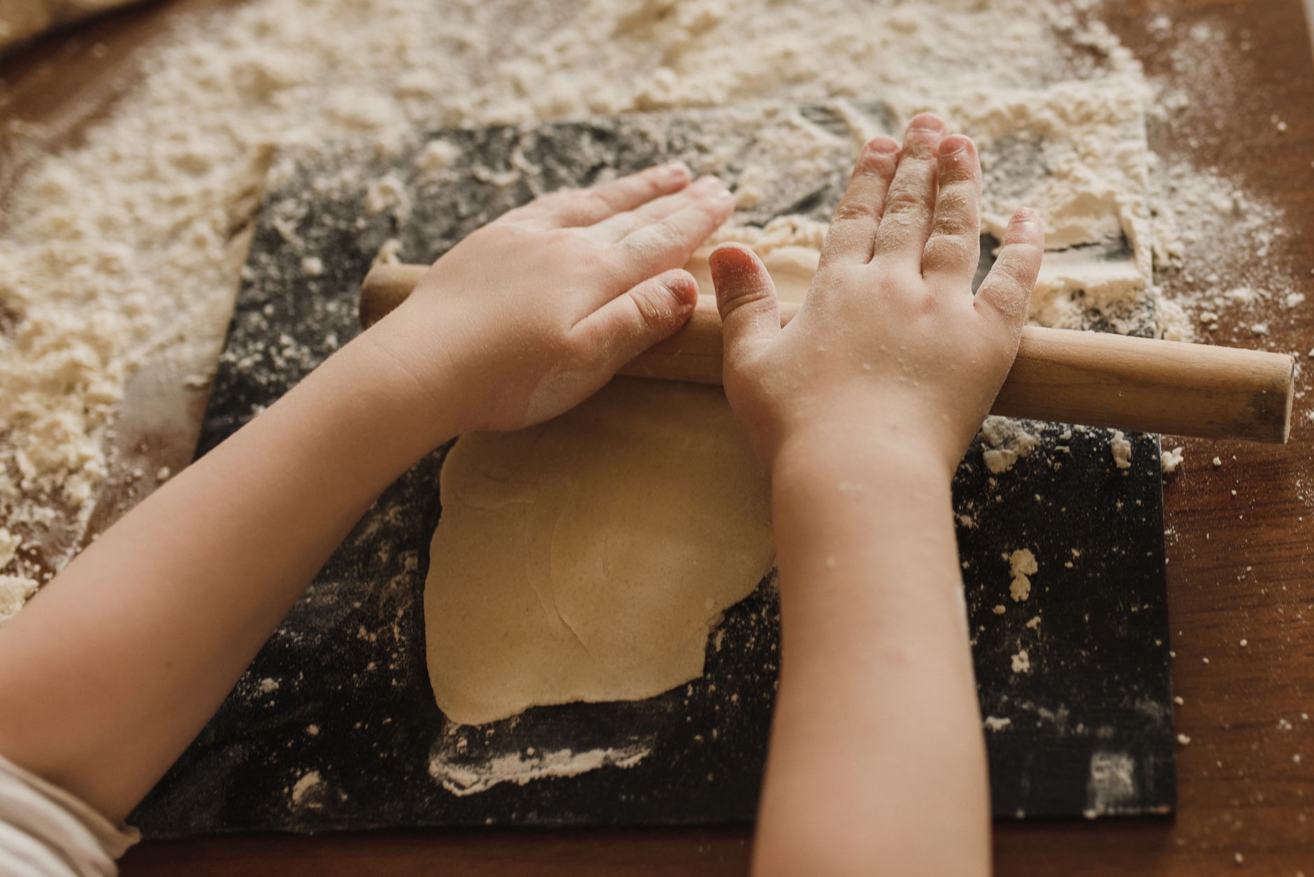 Small hands helping mix ingredients in a bowl