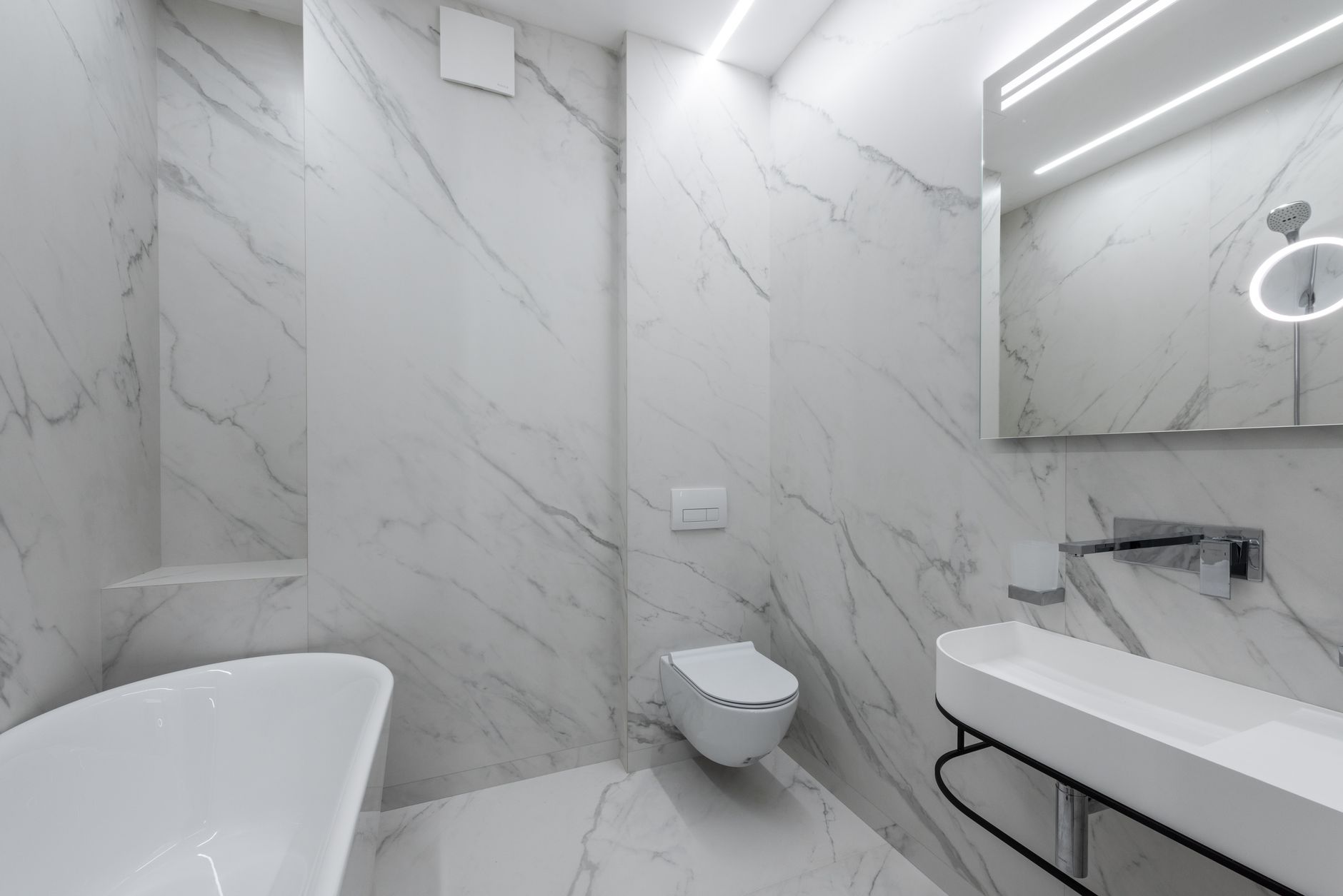 Best toilet fill valve: a marble bathroom with a wall-hung toilet