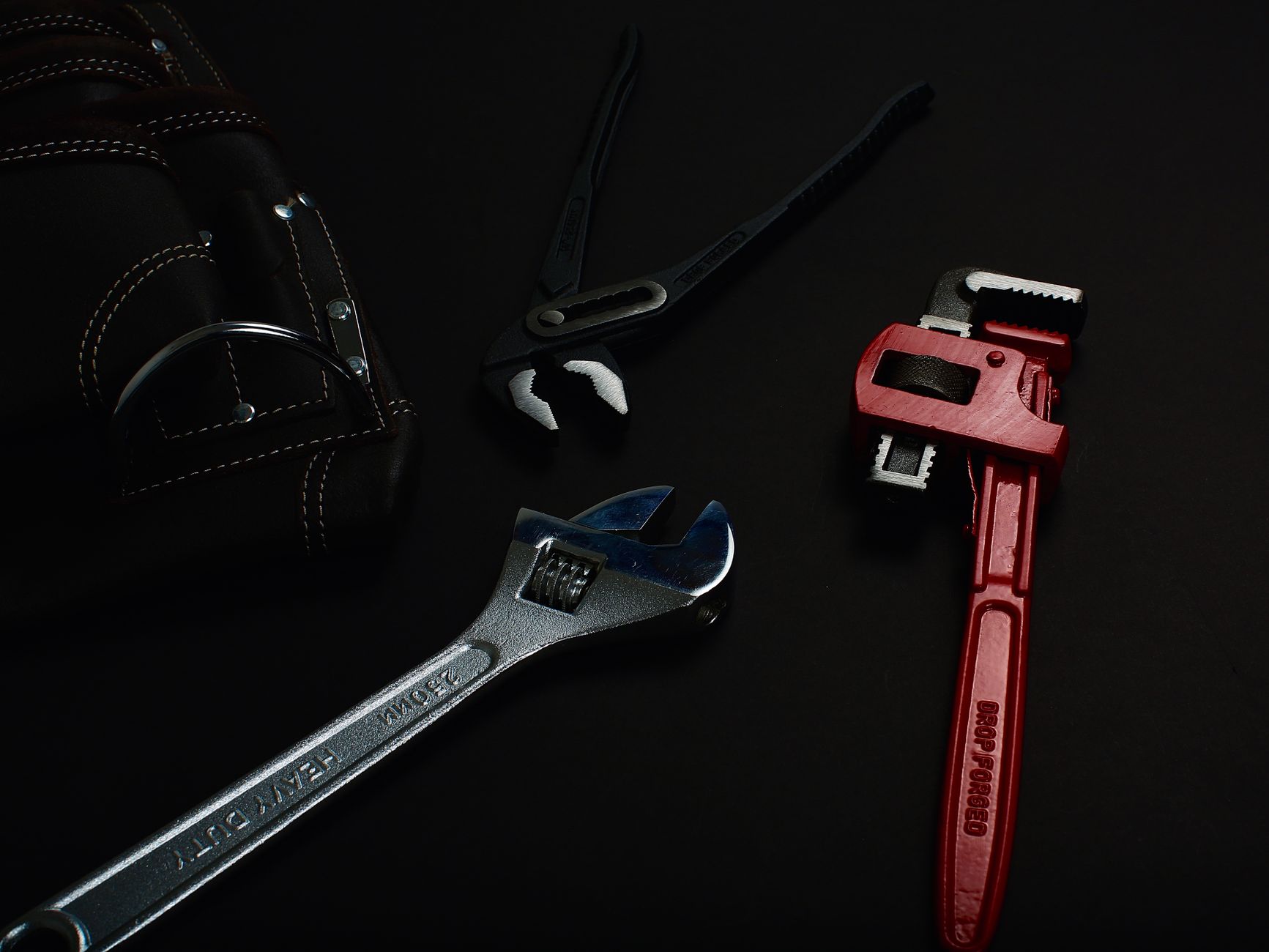 Wrenches laid out on a dark surface