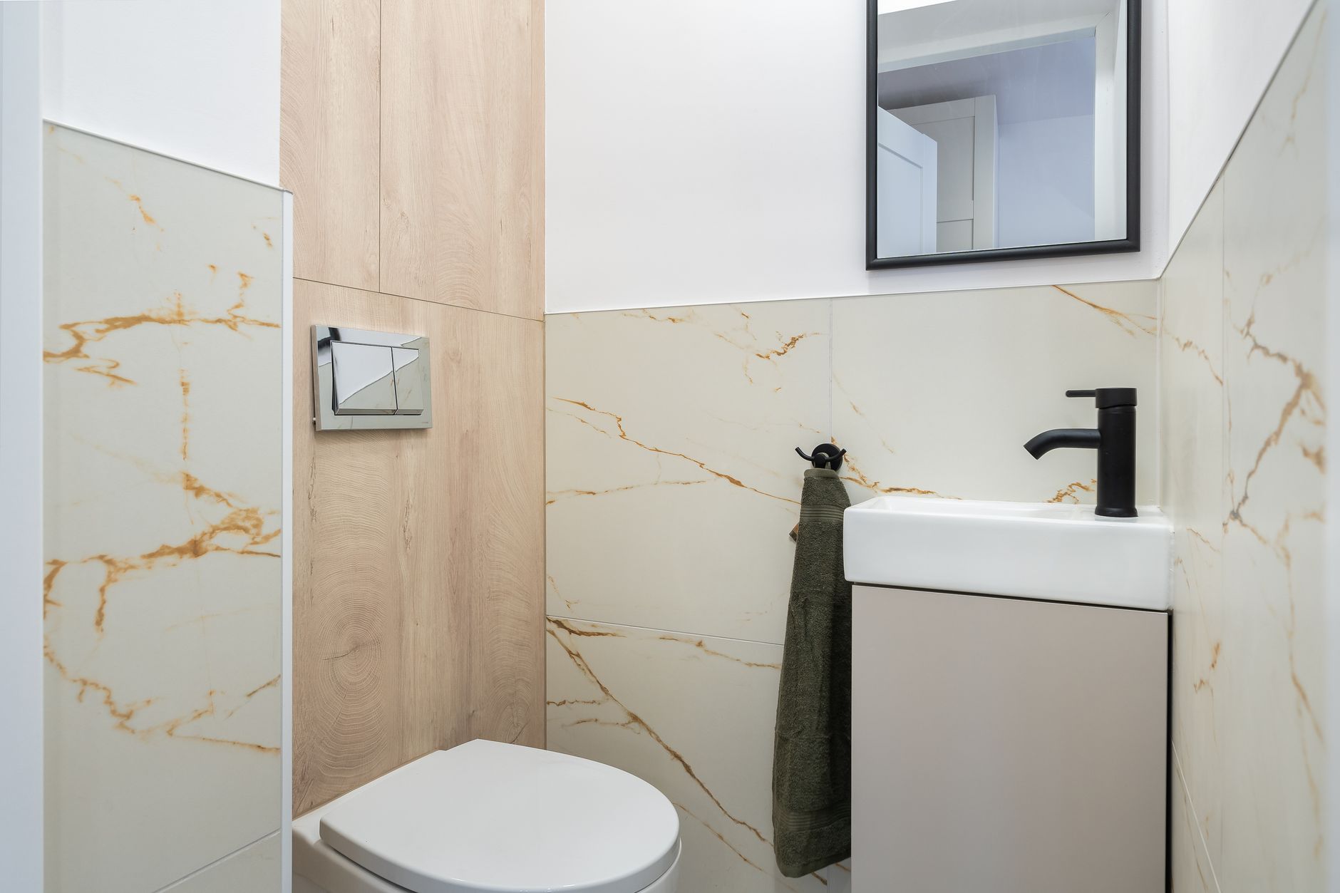 A small bathroom with a toilet and compact vanity