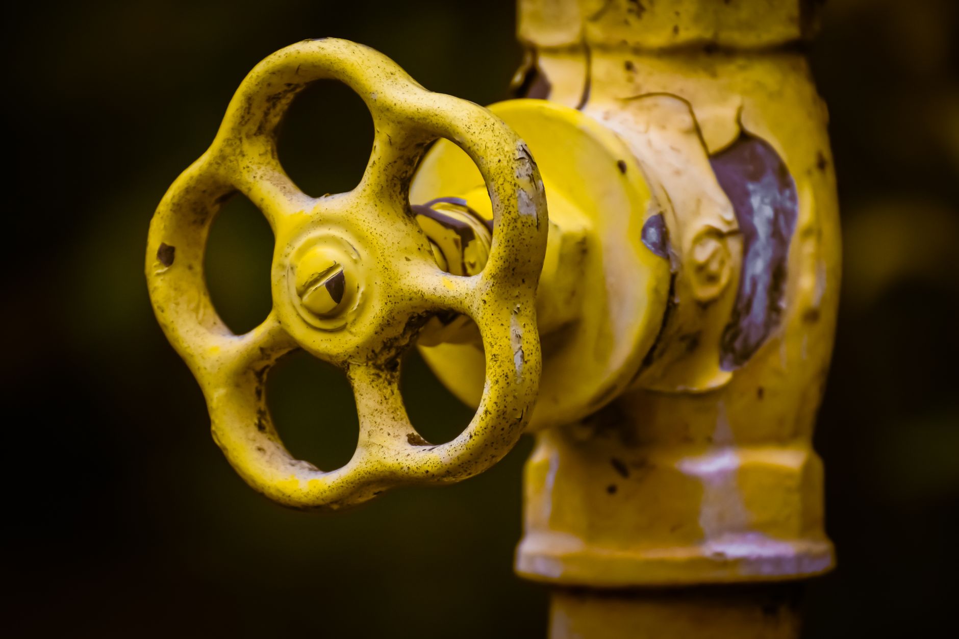 A yellow water valve on a pipe