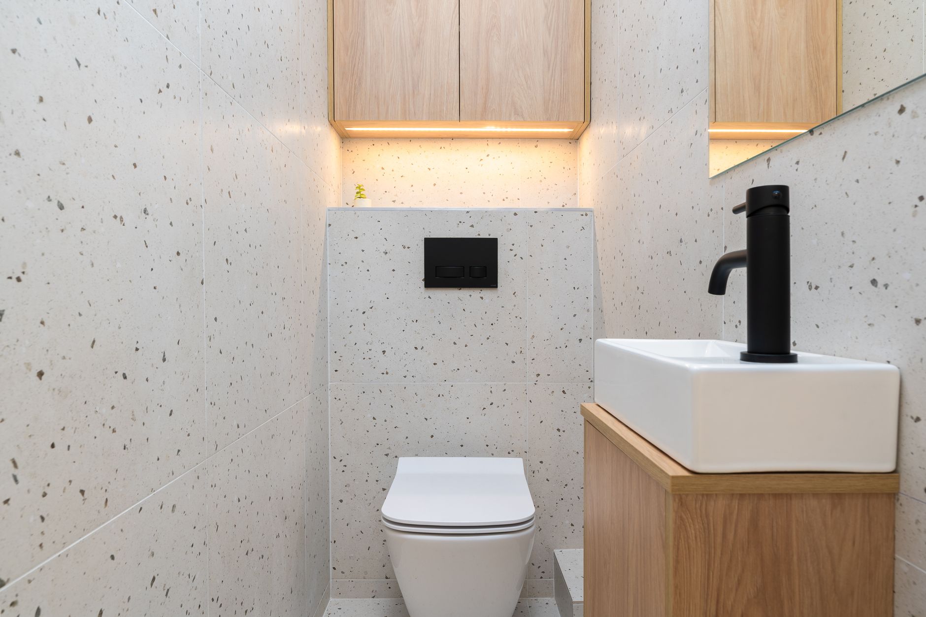 A compact bathroom with a wall-hung toilet