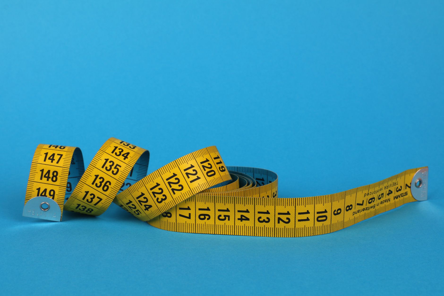 A measuring tape on a blue background