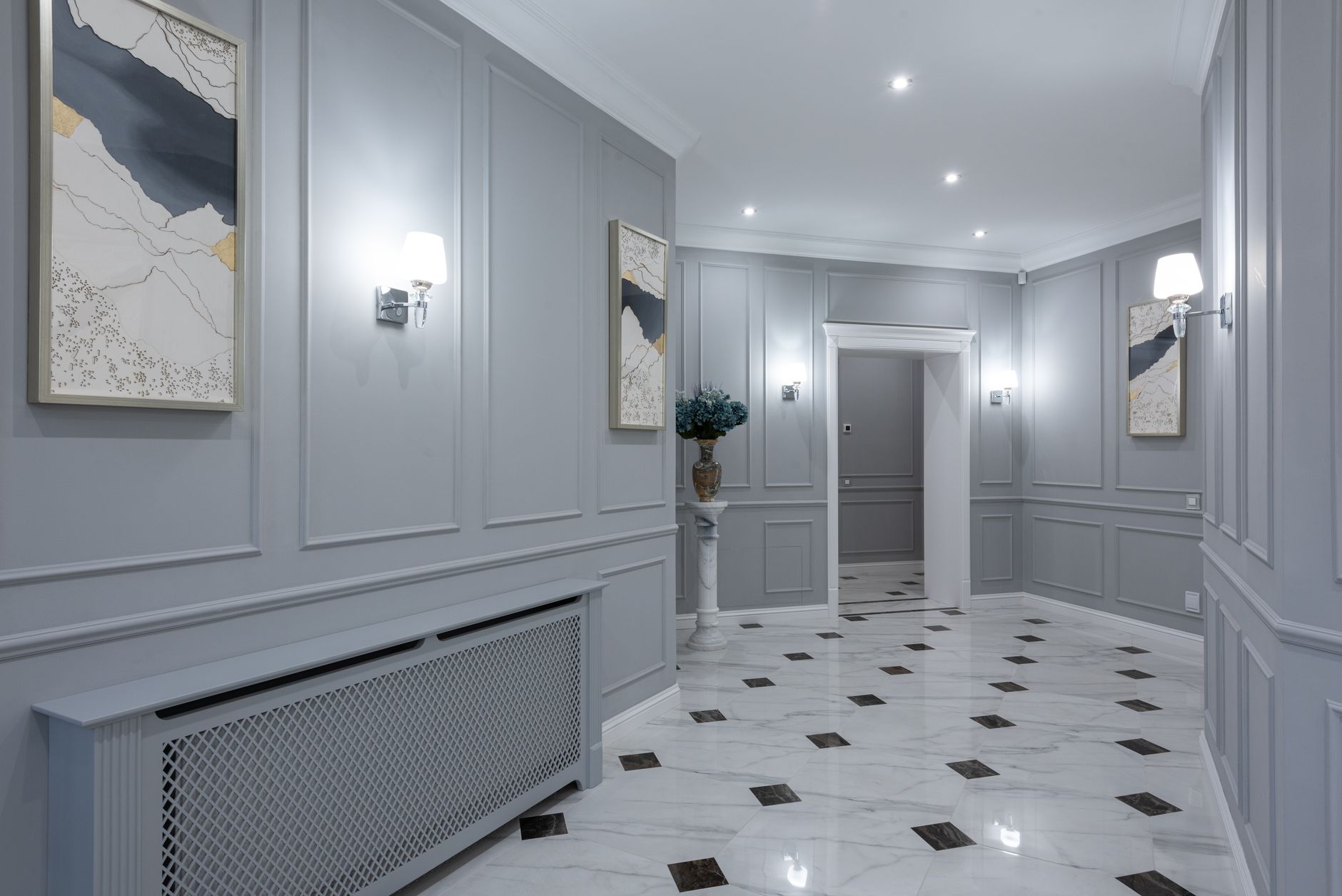 A softly lit hallway with wall sconces