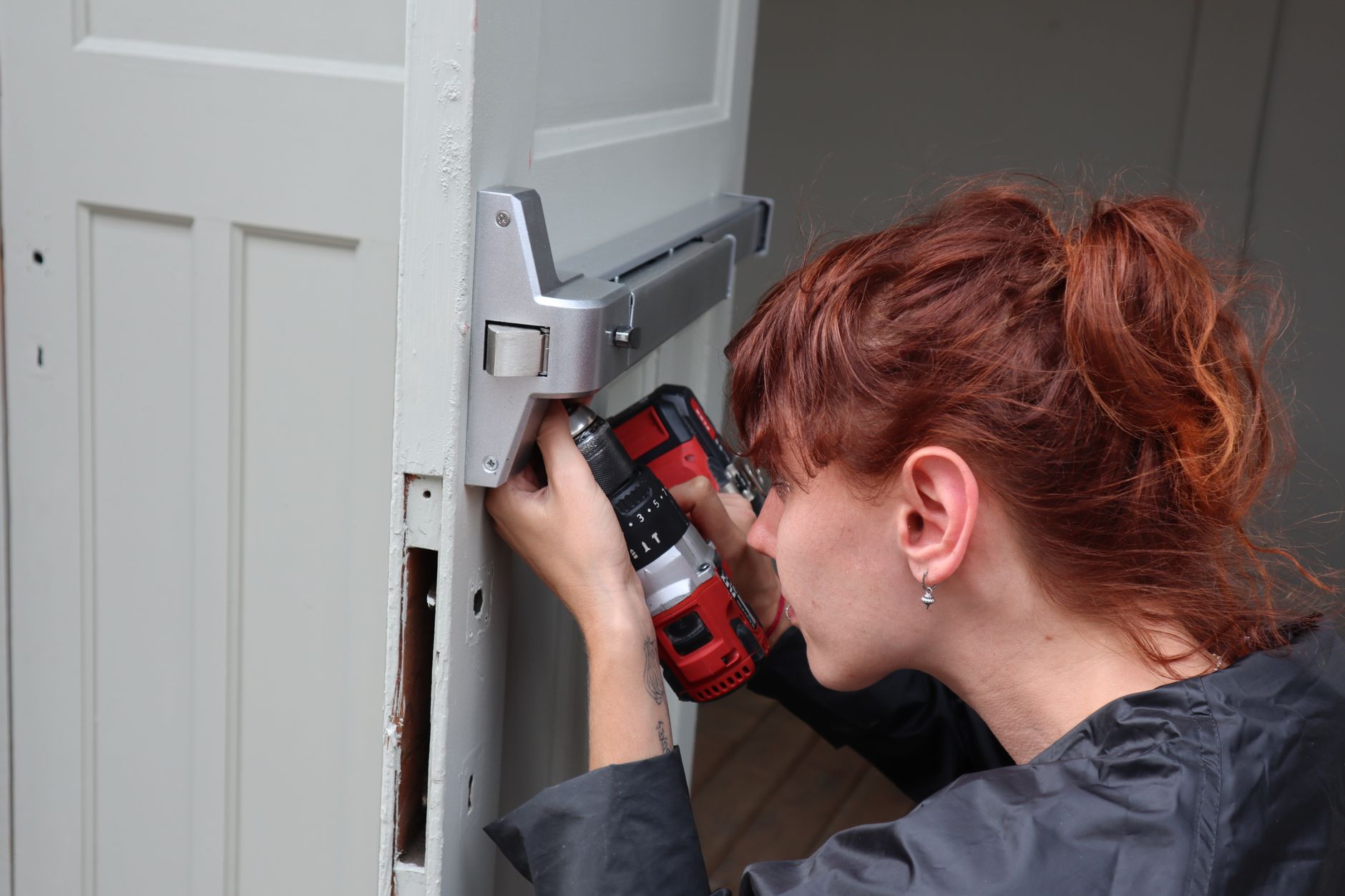 A homeowner fixing a door at home