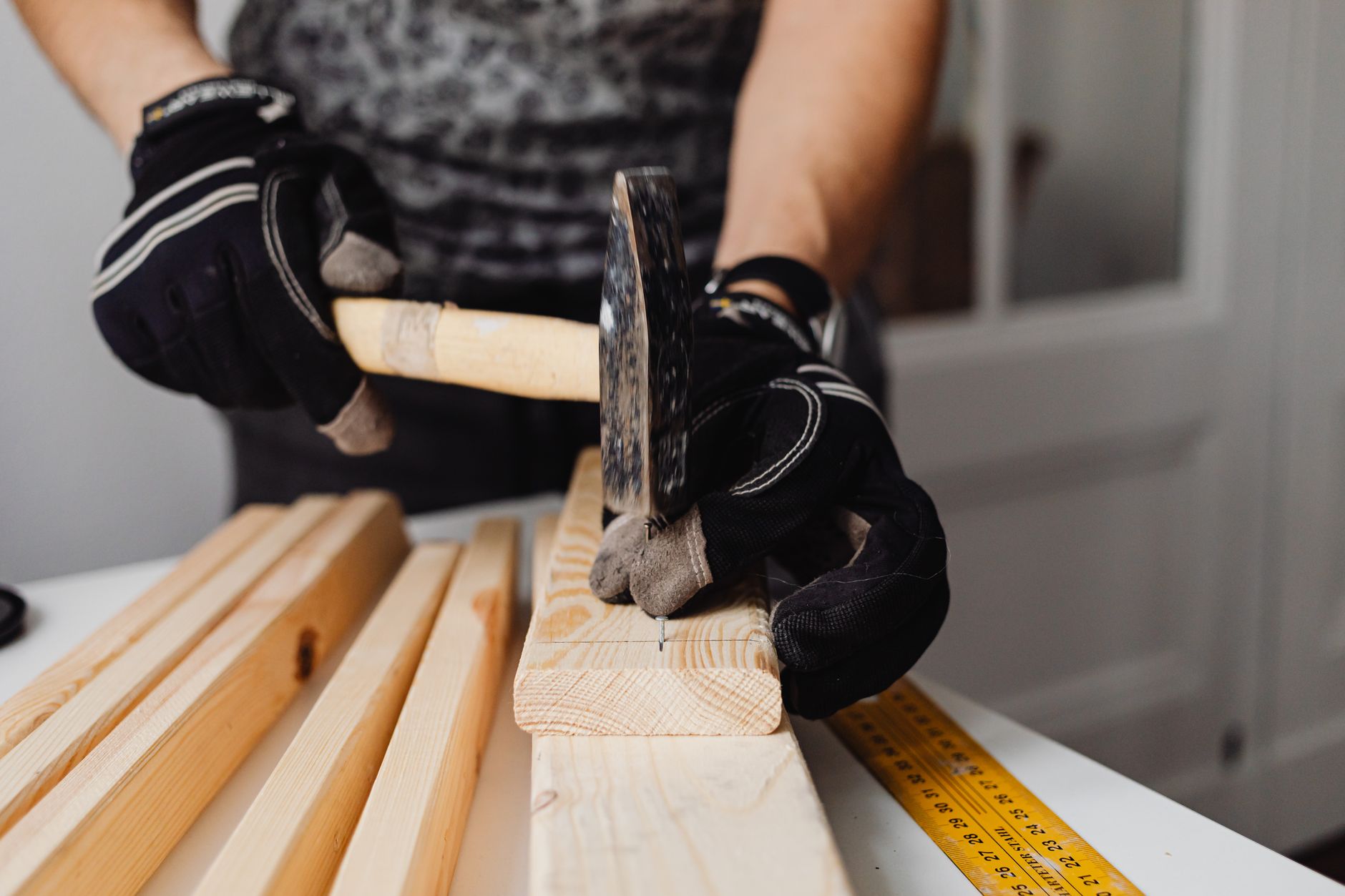 A hammer and nails on a piece of wood