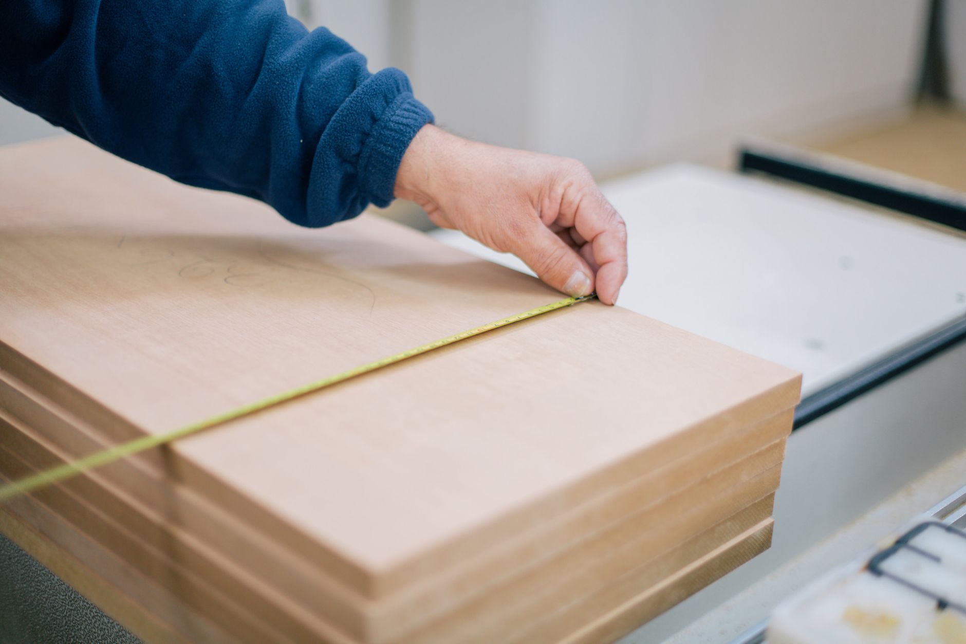 A measuring tape on a wooden plank