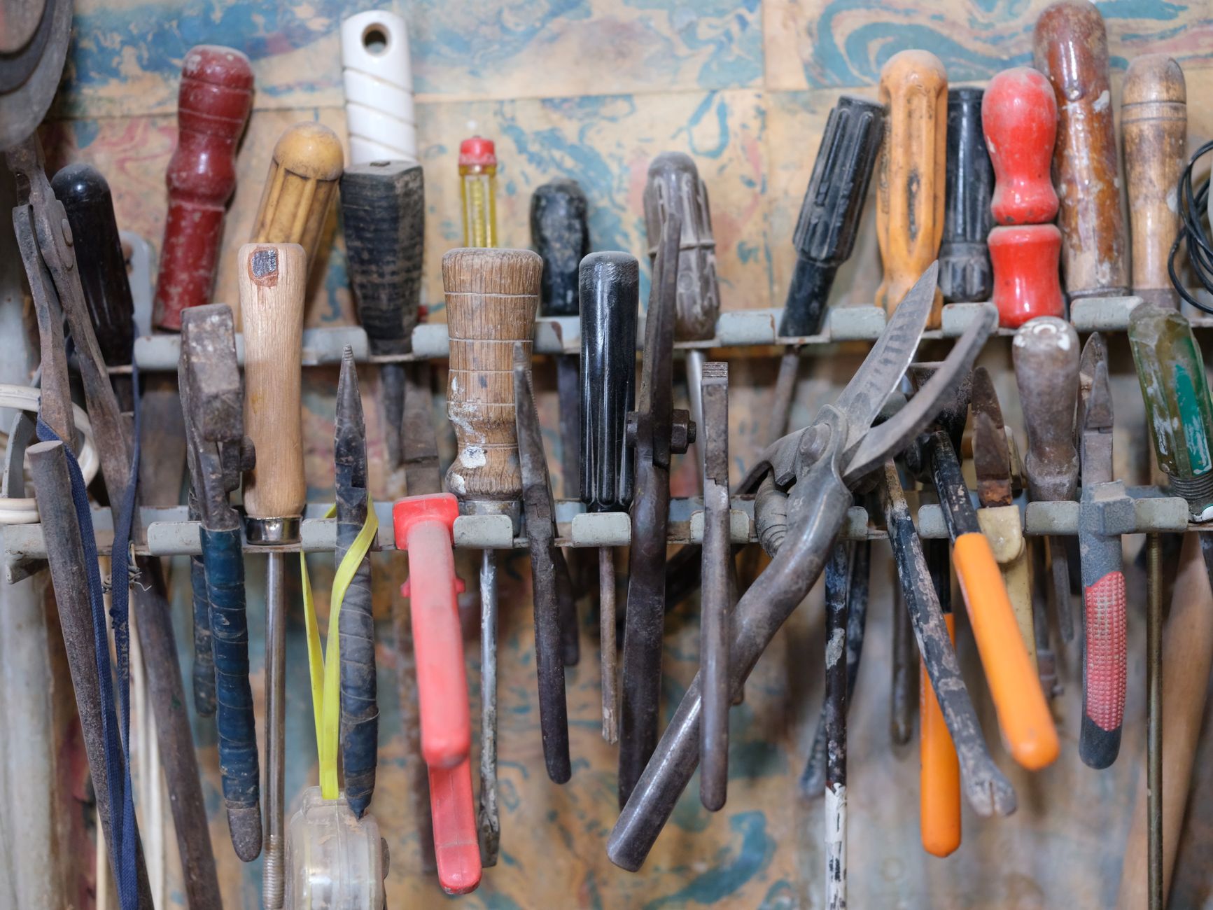 Screwdrivers and pliers in a wall rack
