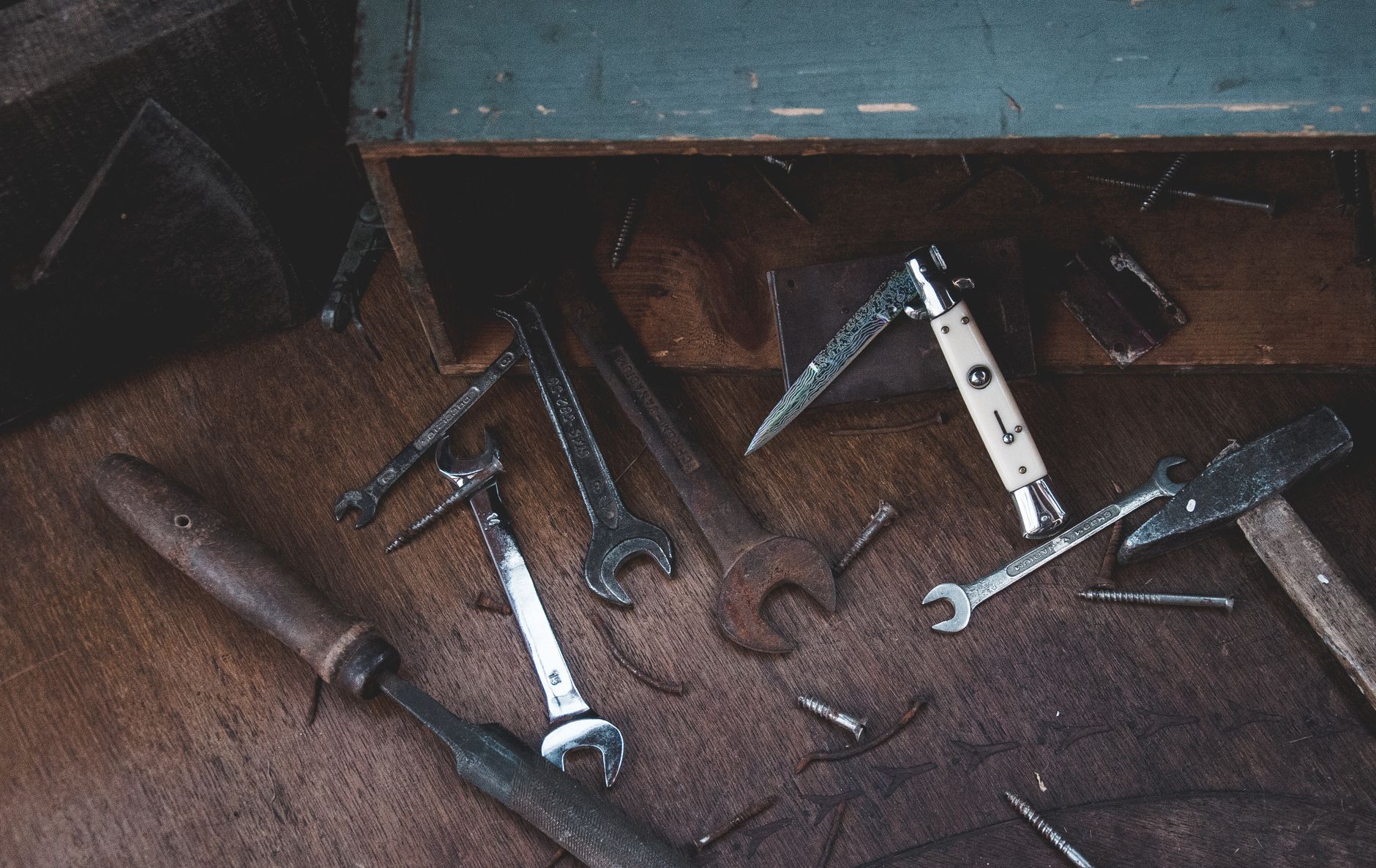 Wrenches on a worn wooden surface