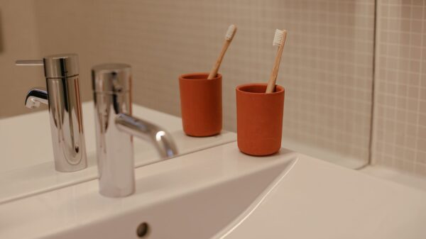 Best toothbrush holder: toothbrushes in cups beside a bathroom sink