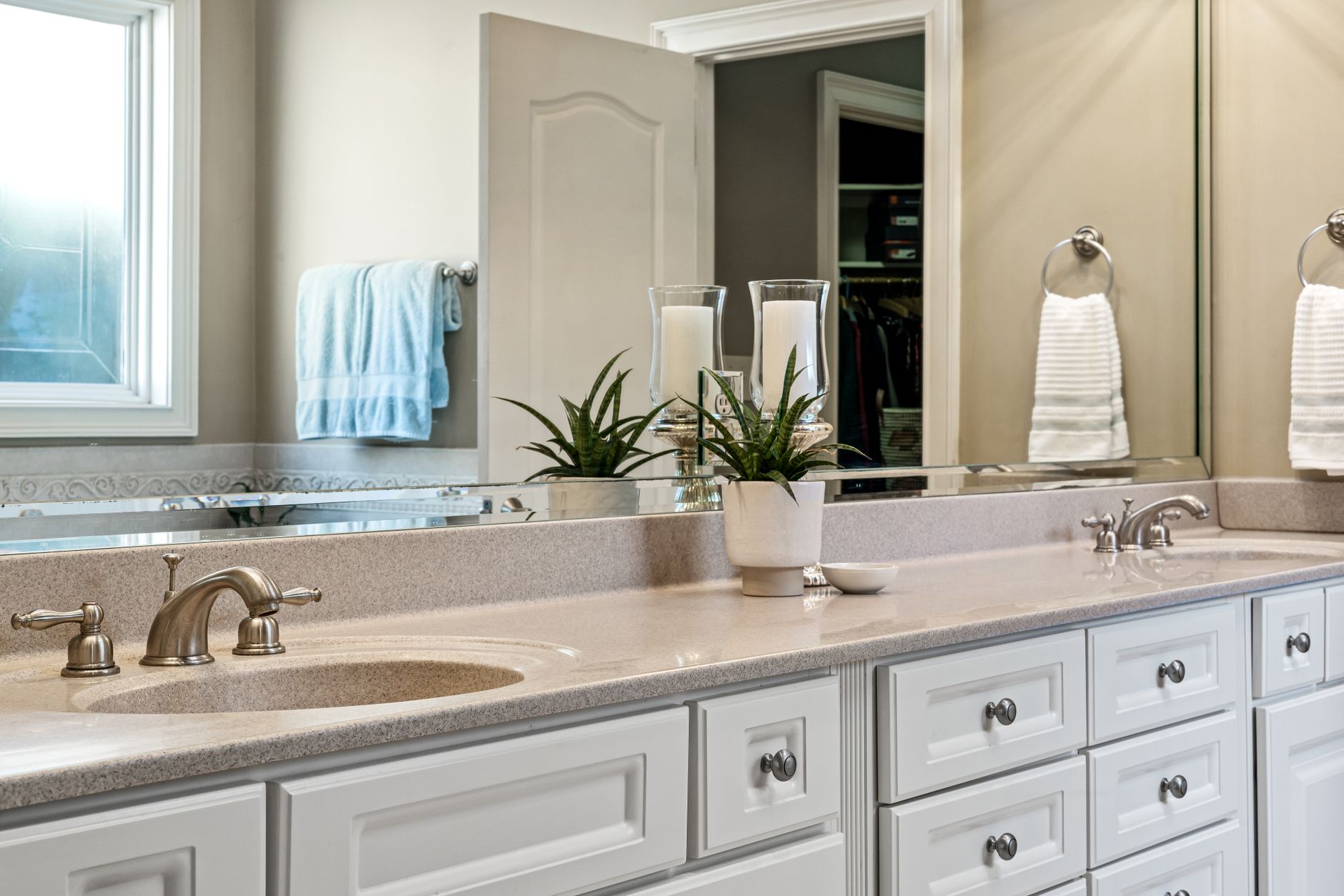 A double vanity with plants and towels