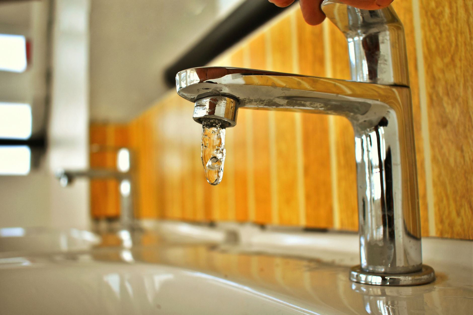Water dripping from a bathroom faucet