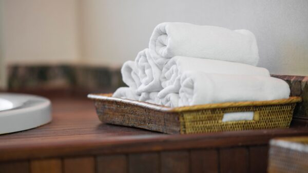 Best towel warmer: rolled white towels in a basket