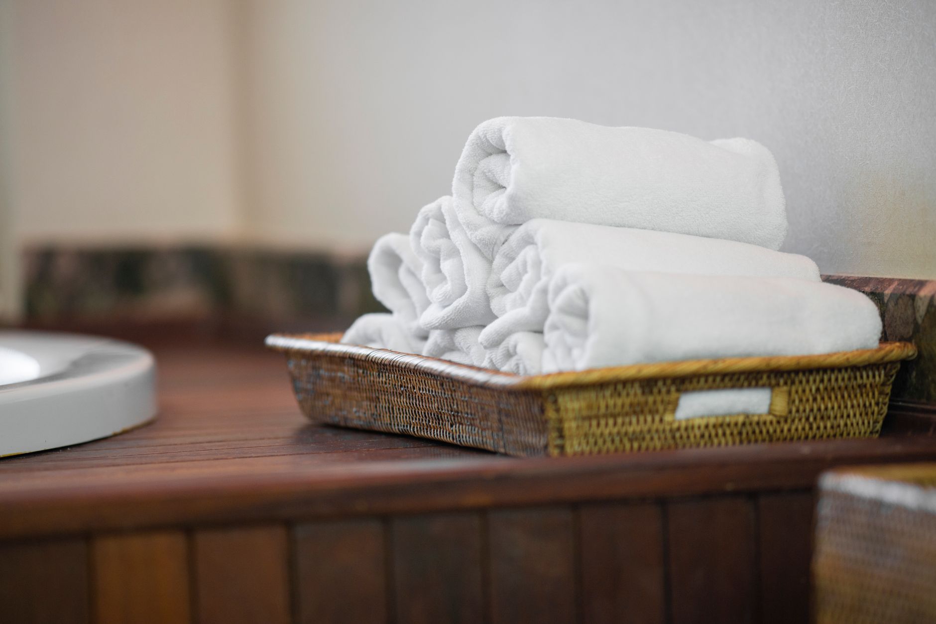 Best towel warmer: rolled white towels in a basket