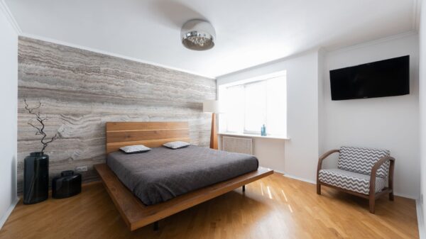 A bright bedroom with a wood floor