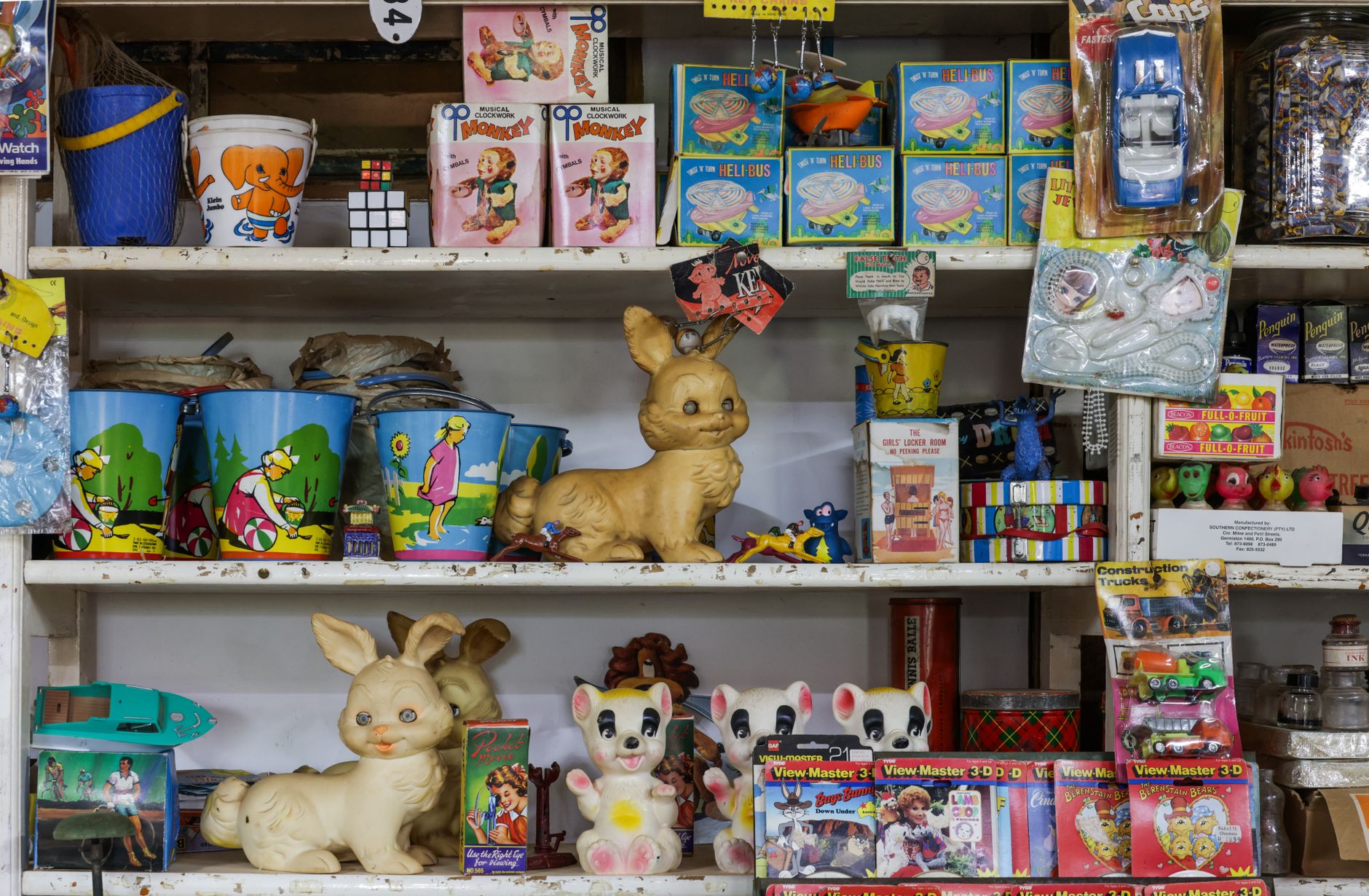 Toy bins lined up on a low shelf