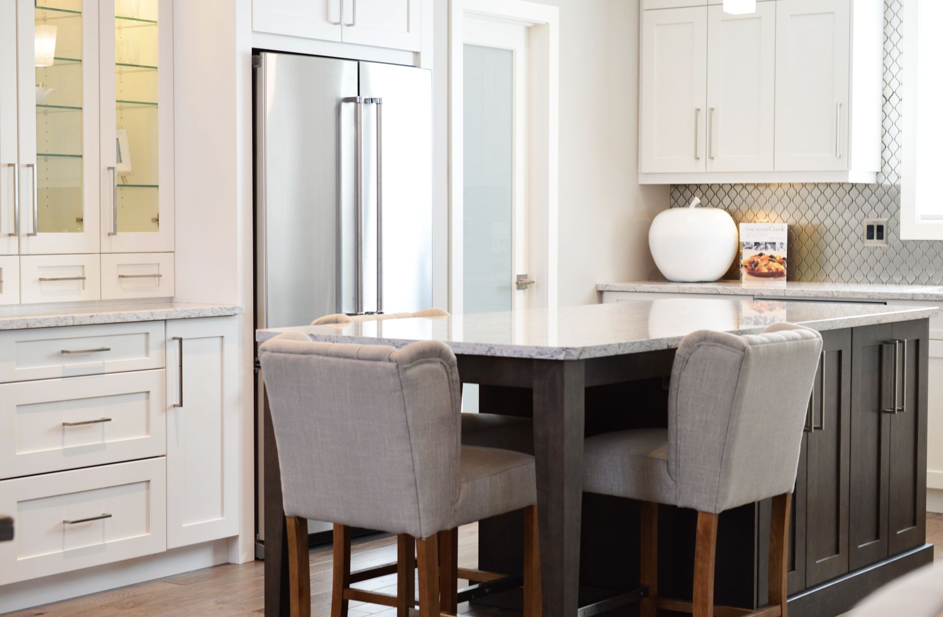 A kitchen with an island and stools