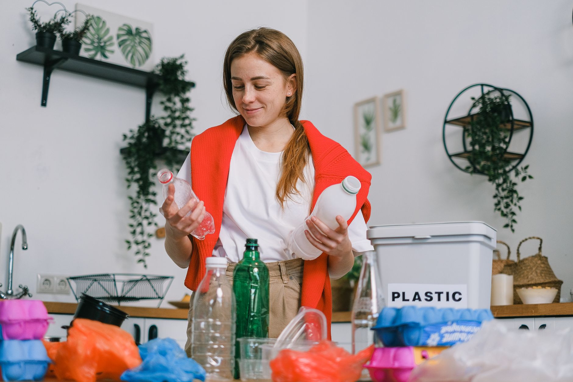 A woman sorting plastic bottles for recycling
