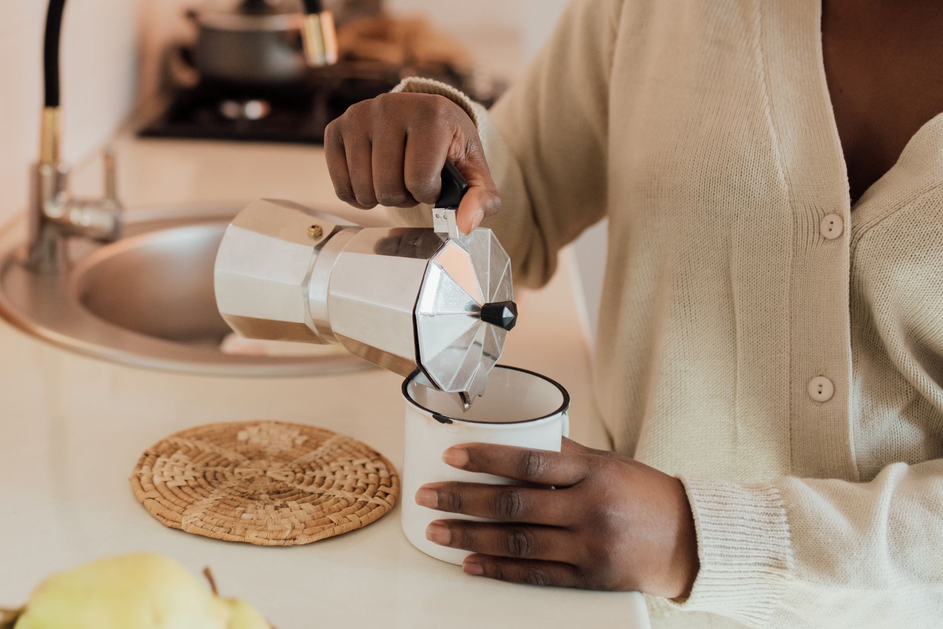 Pouring hot coffee in a kitchen